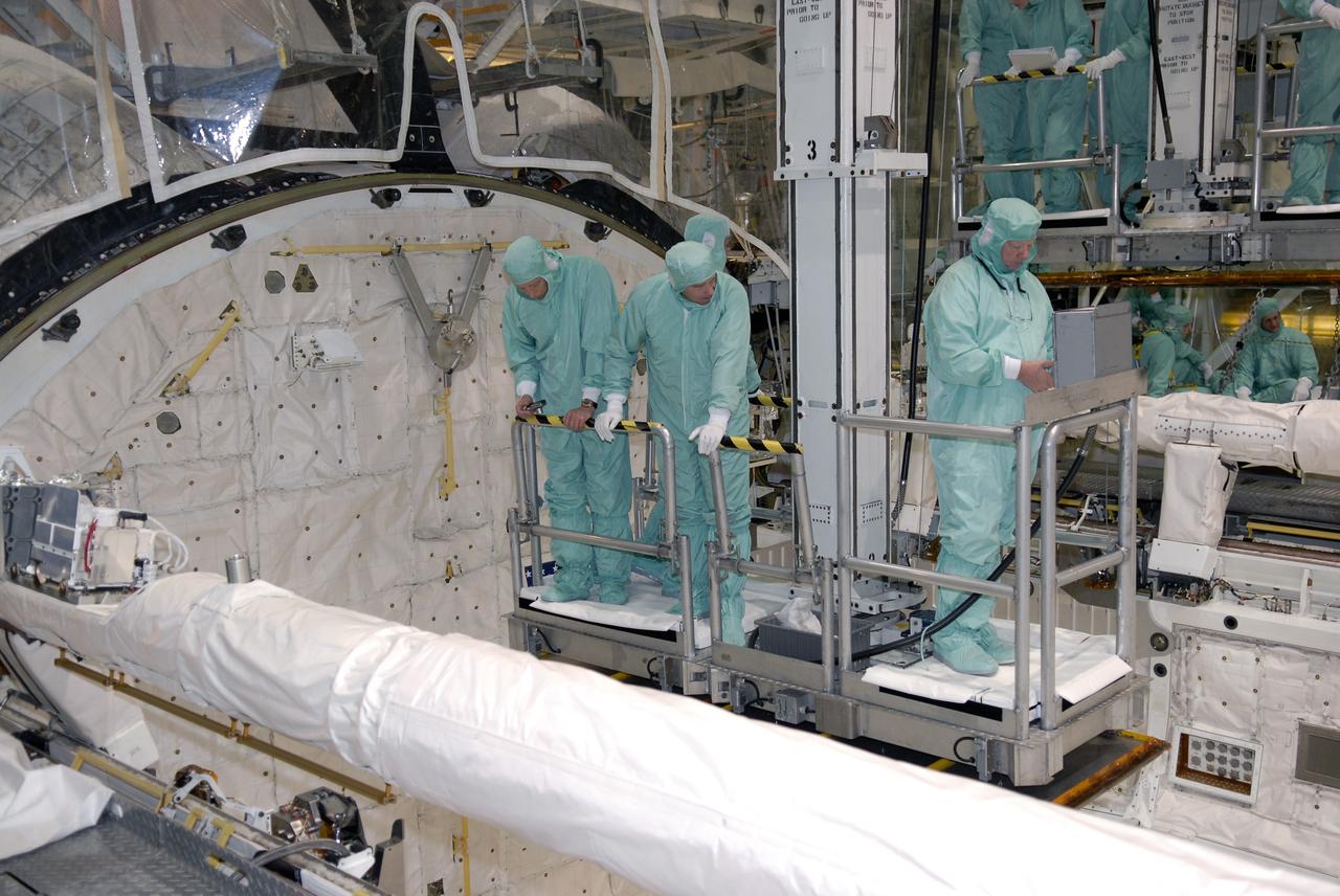 CAPE CANAVERAL, Fla. –  In Orbiter Processing Facility 2 at NASA's Kennedy Space Center, STS-126 Commander Chris Ferguson (left) and Mission Specialist Steve Bowen get a close look at hardware inside space shuttle Endeavour's payload bay.  Members of space shuttle Endeavour's STS-126 crew are at Kennedy to participate in a crew equipment interface test, or CEIT.  The CEIT provides experience handling tools, equipment and hardware they will use on the mission. Endeavour will deliver a multi-purpose logistics module to the International Space Station on the STS-126 mission. Launch is targeted for Nov. 10.  Photo credit: NASA/Kim Shiflett