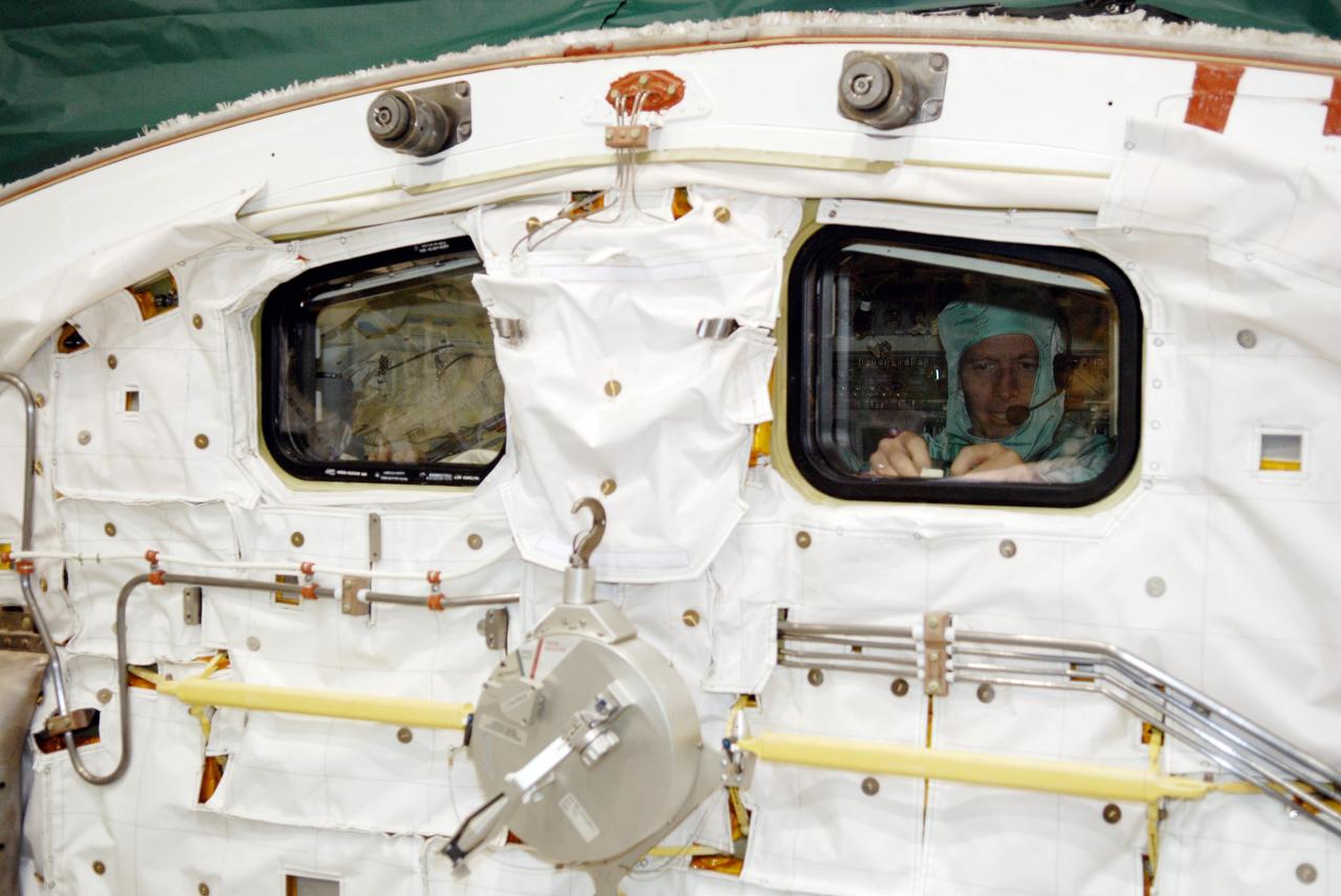 CAPE CANAVERAL, Fla. –  In Orbiter Processing Facility 2 at NASA's Kennedy Space Center, STS-126 Commander Chris Ferguson is seen in the mid-deck of space shuttle Endeavour during inspection of hardware.  Members of space shuttle Endeavour's STS-126 crew are at Kennedy to participate in a crew equipment interface test, or CEIT.  The CEIT provides experience handling tools, equipment and hardware they will use on the mission. Endeavour will deliver a multi-purpose logistics module to the International Space Station on the STS-126 mission. Launch is targeted for Nov. 10.  Photo credit: NASA/Kim Shiflett