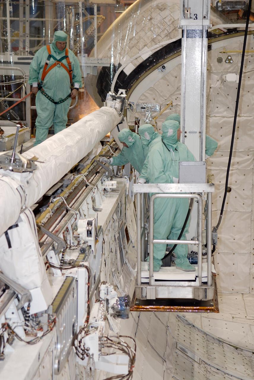CAPE CANAVERAL, Fla. –  In Orbiter Processing Facility 2 at NASA's Kennedy Space Center, STS-126 crew members are lowered inside space shuttle Endeavour's payload bay to inspect hardware like the shuttle's robotic arm and orbiter boom sensor system.  Members of space shuttle Endeavour's STS-126 crew are at Kennedy to participate in a crew equipment interface test, or CEIT.  The CEIT provides experience handling tools, equipment and hardware they will use on the mission. Endeavour will deliver a multi-purpose logistics module to the International Space Station on the STS-126 mission. Launch is targeted for Nov. 10.  Photo credit: NASA/Kim Shiflett