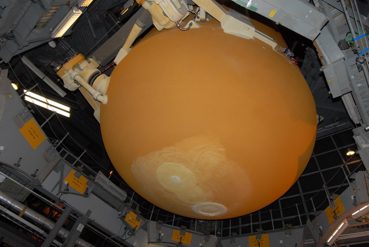 CAPE CANAVERAL, Fla. – In the Vehicle Assembly Building at NASA's Kennedy Space Center, the bottom of the external tank for space shuttle Atlantis is seen as it is lifted out of the checkout cell.  The tank will be moved to high bay 3 and lowered toward the solid rocket boosters for mating.  The tank and boosters will be secured on the mobile launcher platform below.  Atlantis' STS-125 mission is the fifth and final shuttle servicing mission to NASA’s Hubble Space Telescope.  Launch is targeted for Oct. 8.    Photo credit: NASA/Jack Pfaller