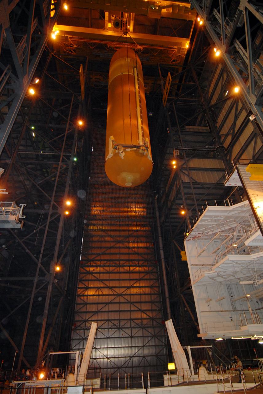CAPE CANAVERAL, Fla. – In the Vehicle Assembly Building at NASA's Kennedy Space Center, the external tank for space shuttle Atlantis is moved across the transom to high bay 3 where it will be lowered toward the solid rocket boosters for mating. The tank and boosters will be secured on the mobile launcher platform below.  Atlantis' STS-125 mission is the fifth and final shuttle servicing mission to NASA’s Hubble Space Telescope.  Launch is targeted for Oct. 8.    Photo credit: NASA/Jack Pfaller