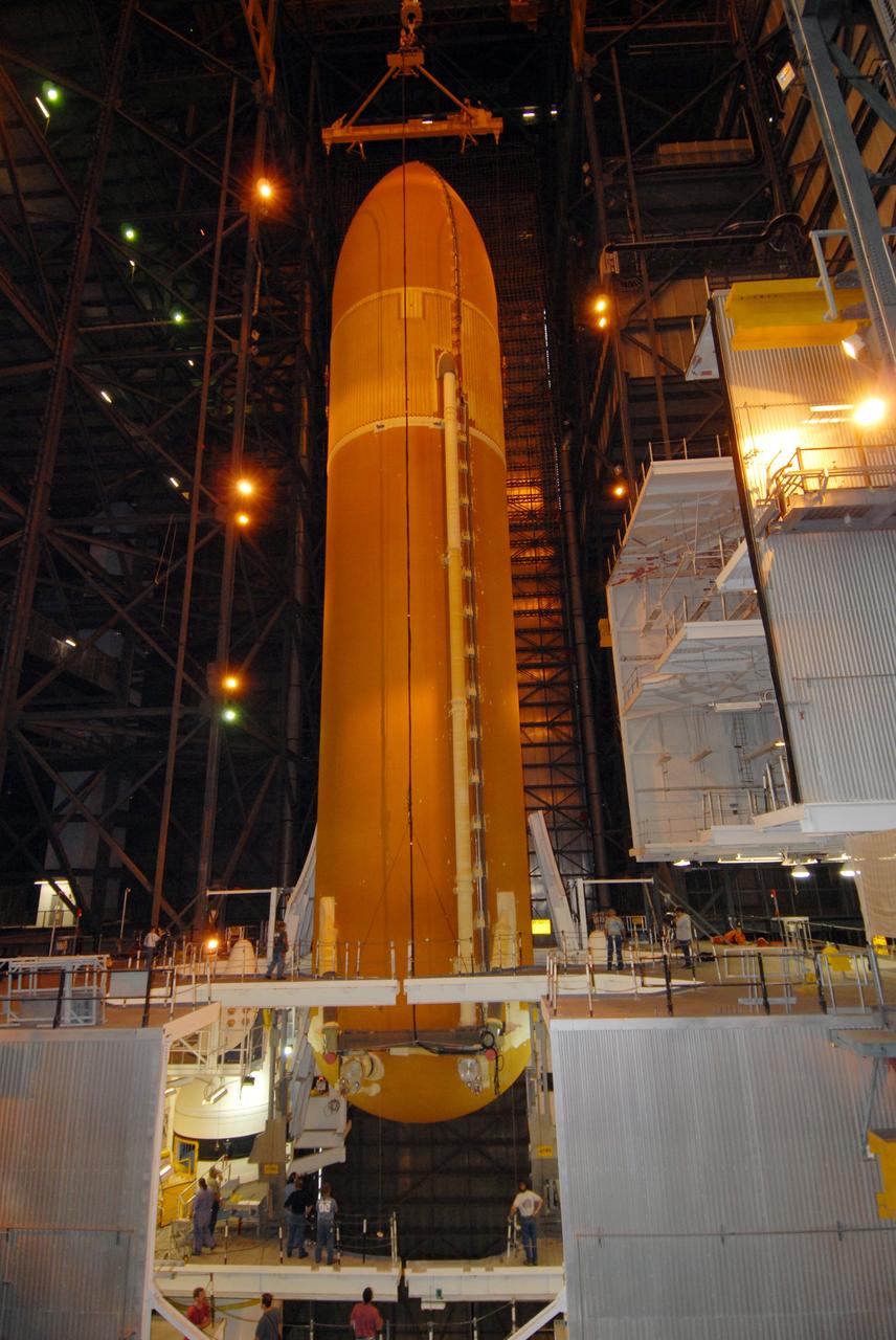 CAPE CANAVERAL, Fla. – In the Vehicle Assembly Building at NASA's Kennedy Space Center, the e3ternal tank for space shuttle Atlantis is lowered between the solid rocket boosters for mating. The tank and boosters will be secured on the mobile launcher platform below.  Atlantis' STS-125 mission is the fifth and final shuttle servicing mission to NASA’s Hubble Space Telescope.  Launch is targeted for Oct. 8.    Photo credit: NASA/Jack Pfaller