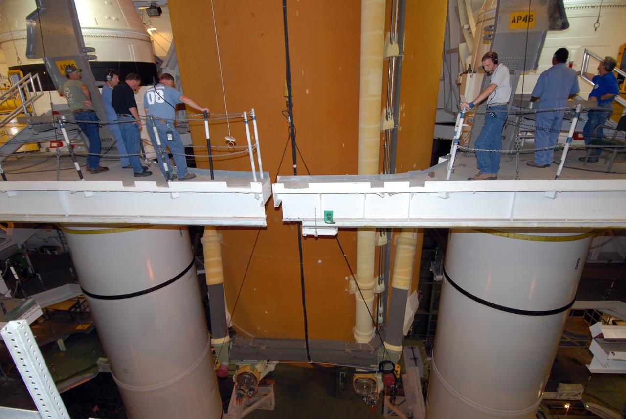 CAPE CANAVERAL, Fla. – In the Vehicle Assembly Building at NASA's Kennedy Space Center, the external tank for space shuttle Atlantis is lowered between the solid rocket boosters for mating on the mobile launcher platform.   Atlantis' STS-125 mission is the fifth and final shuttle servicing mission to NASA’s Hubble Space Telescope.  Launch is targeted for Oct. 8.    Photo credit: NASA/Jack Pfaller