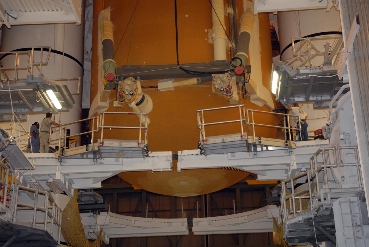 CAPE CANAVERAL, Fla. – In the Vehicle Assembly Building at NASA's Kennedy Space Center, the external tank for space shuttle Atlantis is lowered between the solid rocket boosters for mating on the mobile launcher platform.  Atlantis' STS-125 mission is the fifth and final shuttle servicing mission to NASA’s Hubble Space Telescope.  Launch is targeted for Oct. 8.    Photo credit: NASA/Jack Pfaller
