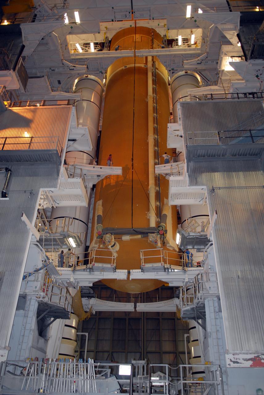 CAPE CANAVERAL, Fla. – In the Vehicle Assembly Building at NASA's Kennedy Space Center, the external tank for space shuttle Atlantis is lowered between the solid rocket boosters for mating on the mobile launcher platform.  Atlantis' STS-125 mission is the fifth and final shuttle servicing mission to NASA’s Hubble Space Telescope.  Launch is targeted for Oct. 8.    Photo credit: NASA/Jack Pfaller