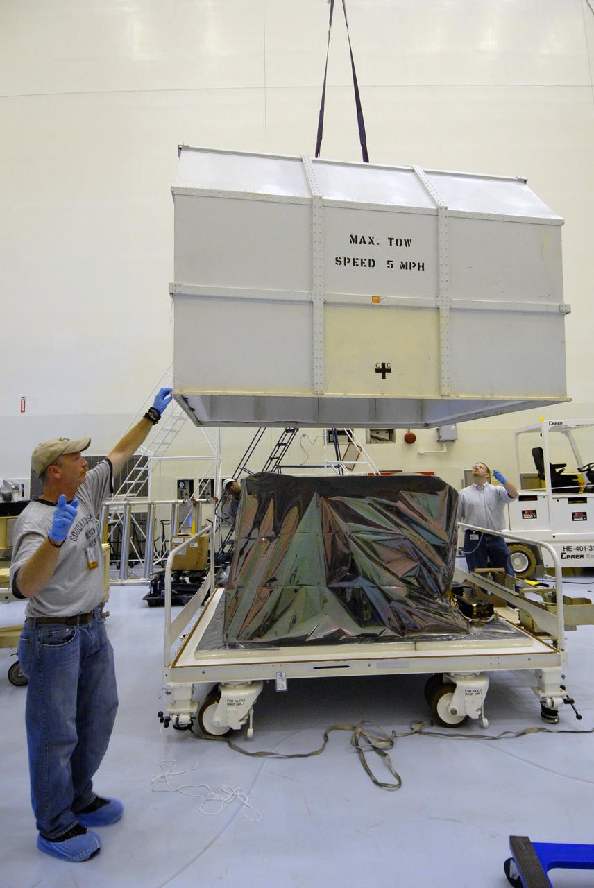 CAPE CANAVERAL, Fla. –  In the Payload Hazardous Servicing Facility at NASA's Kennedy Space Center, a crane lifts the cover of the shipping container holding the Fine Guidance Sensor, or FGS. The FGS will be integrated onto the Orbital Replacement Unit carrier in the clean room of the facility. The sensor will extend the life of the pointing control system on the Hubble Space Telescope. On the mission, this FGS will replace one of the three sensors that is failing and thus outfit the telescope with two completely healthy units, which are needed.  A third, older FGS aboard the telescope will provide additional target-pointing efficiency and redundancy.  Space shuttle Atlantis is targeted to launch on the STS-125 mission Oct. 8.  Photo credit: NASA/Jack Pfaller