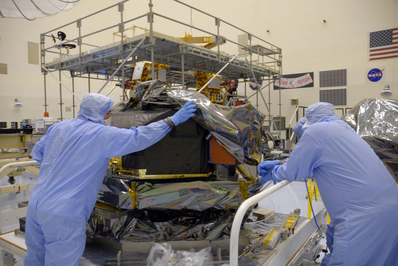 CAPE CANAVERAL, Fla. –   In the Payload Hazardous Servicing Facility at NASA's Kennedy Space Center, workers begin removing the protective cover from the Hubble Fine Guidance Sensor, or FGS.  The FGS will be integrated onto the Orbital Replacement Unit carrier in the clean room of the facility. The sensor will extend the life of the pointing control system on the Hubble Space Telescope. On the mission, this FGS will replace one of the three sensors that is failing and thus outfit the telescope with two completely healthy units, which are needed.  A third, older FGS aboard the telescope will provide additional target-pointing efficiency and redundancy.  Space shuttle Atlantis is targeted to launch on the STS-125 mission Oct. 8.   Photo credit: NASA/Jack Pfaller