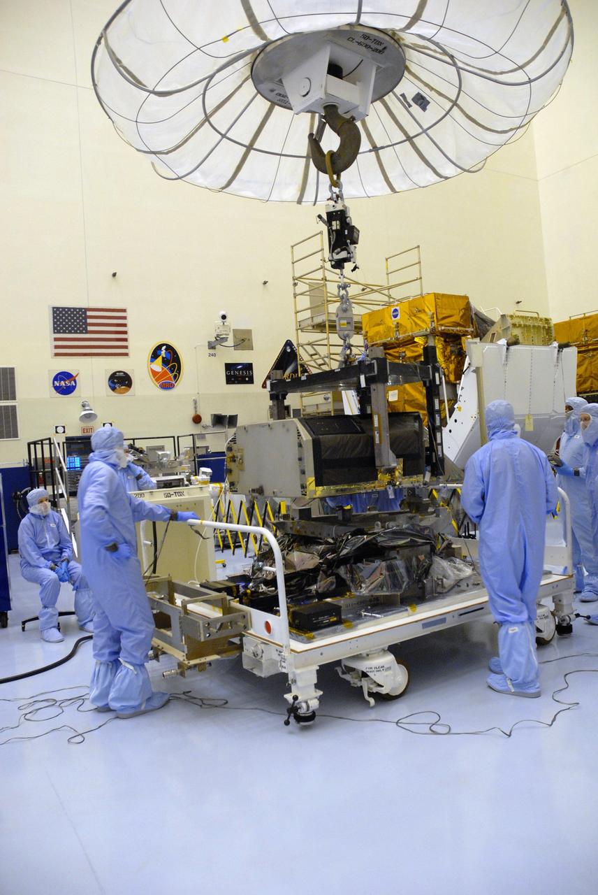 CAPE CANAVERAL, Fla. –  In the Payload Hazardous Servicing Facility at NASA's Kennedy Space Center, an overhead crane lifts the Hubble Fine Guidance Sensor, or FGS.  The FGS will be integrated onto the Orbital Replacement Unit carrier in the clean room of the facility. The sensor will extend the life of the pointing control system on the Hubble Space Telescope. On the mission, this FGS will replace one of the three sensors that is failing and thus outfit the telescope with two completely healthy units, which are needed.  A third, older FGS aboard the telescope will provide additional target-pointing efficiency and redundancy.  Space shuttle Atlantis is targeted to launch on the STS-125 mission Oct. 8.   Photo credit: NASA/Jack Pfaller