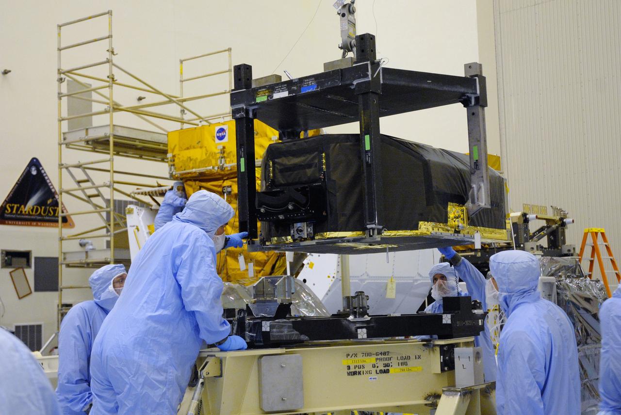 CAPE CANAVERAL, Fla. –   In the Payload Hazardous Servicing Facility at NASA's Kennedy Space Center, technicians watch closely as the Hubble Fine Guidance Sensor, or FGS, is moved to a work stand The FGS will be integrated onto the Orbital Replacement Unit carrier in the clean room of the facility. The sensor will extend the life of the pointing control system on the Hubble Space Telescope. On the mission, this FGS will replace one of the three sensors that is failing and thus outfit the telescope with two completely healthy units, which are needed.  A third, older FGS aboard the telescope will provide additional target-pointing efficiency and redundancy.  Space shuttle Atlantis is targeted to launch on the STS-125 mission Oct. 8.   Photo credit: NASA/Jack Pfaller