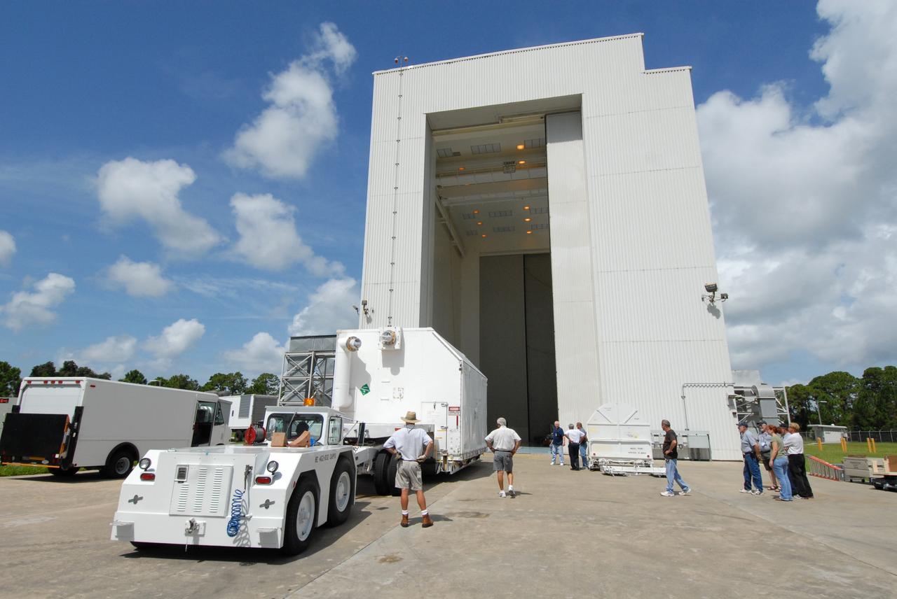 CAPE CANAVERAL, Fla. – A transporter moves the shipping container with the Multi-Use Lightweight Equipment (MULE) carrier toward the open doors of the airlock in the Payload Hazardous Servicing Facility at NASA's Kennedy Space Center. The MULE is part of the payload for the fifth and final shuttle servicing mission to NASA's Hubble Space Telescope, STS-125. The MULE carrier will join the Flight Support System, the Super Lightweight Interchangeable Carrier and the Orbital Replacement Unit Carrier in the Payload Hazardous Servicing Facility where the Hubble payload is being prepared for launch. The Relative Navigation Sensors and the New Outer Blanket Layers will be on the MULE. The payload is scheduled to go to Launch Pad 39A in mid-September to be installed into Atlantis' payload bay. Atlantis is targeted to launch Oct. 8 at 1:34 a.m. EDT. .Photo credit: NASA/Amanda Diller