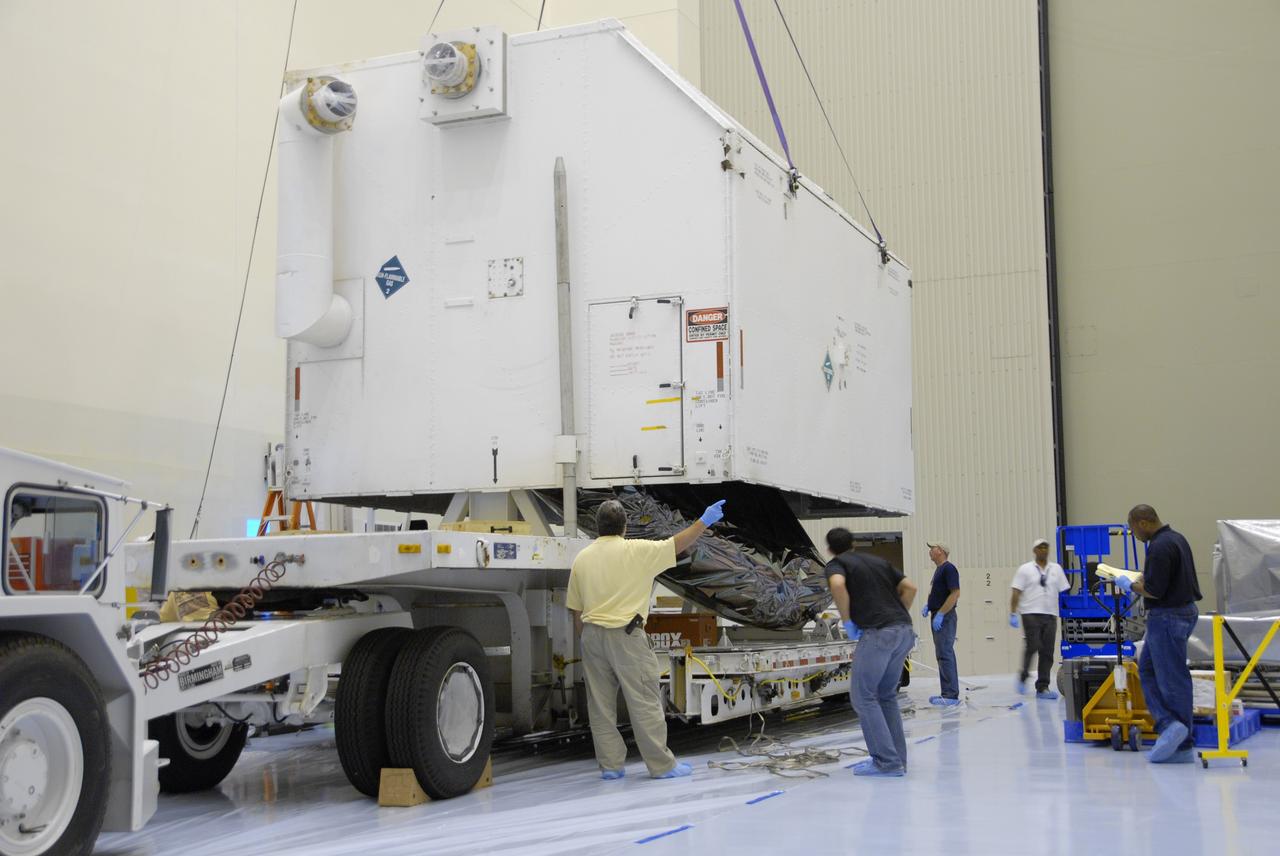 CAPE CANAVERAL, Fla. – In the Payload Hazardous Servicing Facility at NASA's Kennedy Space Center, the cover of the shipping container is lifted to reveal the Multi-Use Lightweight Equipment (MULE) carrier inside. The MULE is part of the payload for the fifth and final shuttle servicing mission to NASA's Hubble Space Telescope, STS-125. The MULE carrier will join the Flight Support System, the Super Lightweight Interchangeable Carrier and the Orbital Replacement Unit Carrier in the Payload Hazardous Servicing Facility where the Hubble payload is being prepared for launch. The Relative Navigation Sensors and the New Outer Blanket Layers will be on the MULE. The payload is scheduled to go to Launch Pad 39A in mid-September to be installed into Atlantis' payload bay.  Atlantis is targeted to launch Oct. 8 at 1:34 a.m. EDT. .Photo credit: NASA/Amanda Diller
