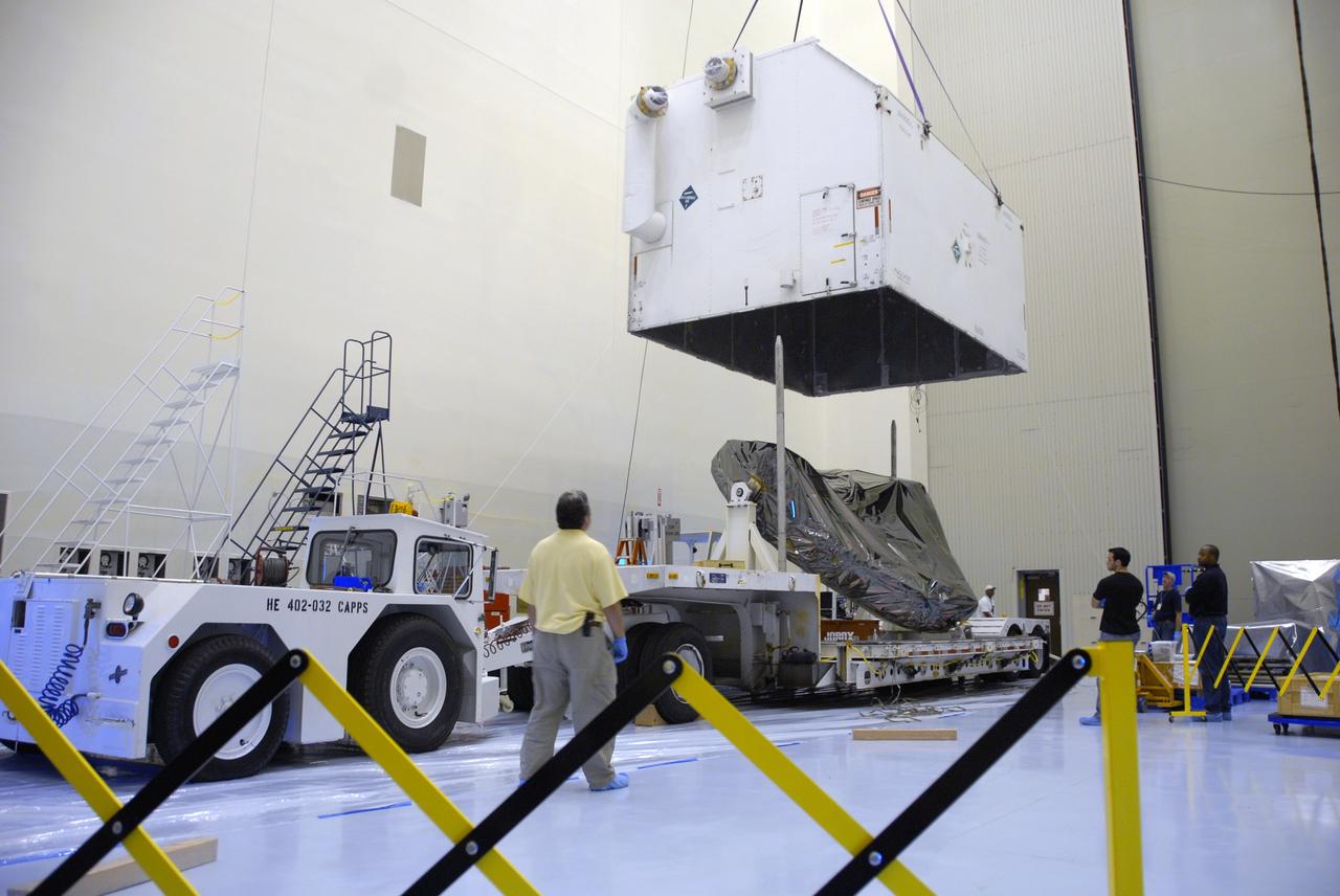 CAPE CANAVERAL, Fla. – In the Payload Hazardous Servicing Facility at NASA's Kennedy Space Center, the cover of the shipping container is lifted to reveal the Multi-Use Lightweight Equipment (MULE) carrier inside. The MULE is part of the payload for the fifth and final shuttle servicing mission to NASA's Hubble Space Telescope, STS-125. The MULE carrier will join the Flight Support System, the Super Lightweight Interchangeable Carrier and the Orbital Replacement Unit Carrier in the Payload Hazardous Servicing Facility where the Hubble payload is being prepared for launch. The Relative Navigation Sensors and the New Outer Blanket Layers will be on the MULE. The payload is scheduled to go to Launch Pad 39A in mid-September to be installed into Atlantis' payload bay.  Atlantis is targeted to launch Oct. 8 at 1:34 a.m. EDT. .Photo credit: NASA/Amanda Diller