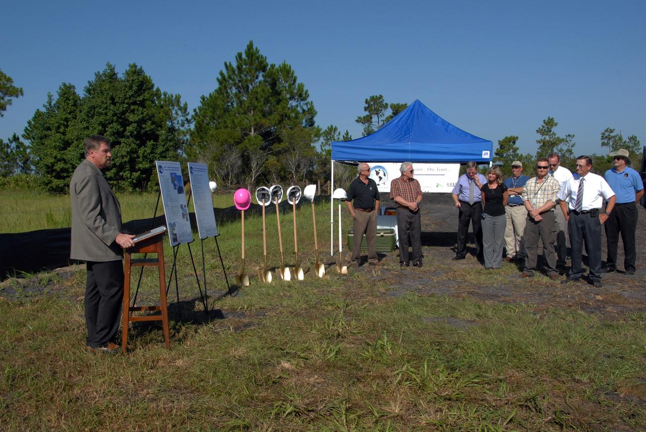 CAPE CANAVERAL, Fla. -   A new weather radar site is dedicated with a mock ground-breaking ceremony.  At the podium is Pat Carr, SLRSC program director with ITT. The site will be used by NASA's Kennedy Space Center, the 45th Space Wing and their customers.  The weather radar is essential in issuing lightning and other severe weather warnings and vital in evaluating lightning launch commit criteria.  The new radar, replacing what was installed 25 years ago, includes Doppler capability to detect winds and identify the type, size and number of precipitation particles.  The site is ideally distant from the launch pads and has unobstructed views of Cape Canaveral Air Force Station and Kennedy.  Photo credit: NASA/Amanda Diller