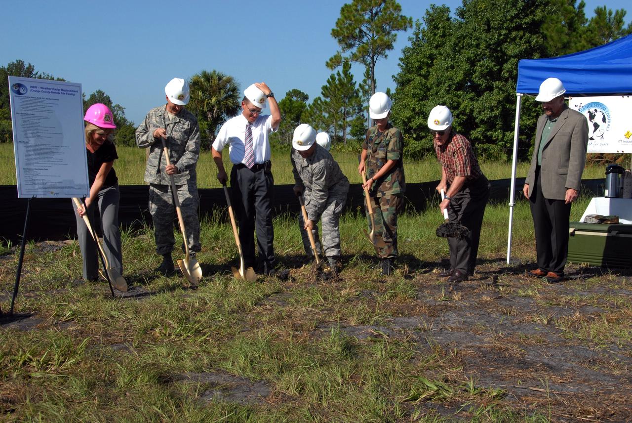 CAPE CANAVERAL, Fla. -   Breaking ground in a mock ceremony for a new weather radar site are (left to right) Project Lead Kim Gwaltney, with SLRSC; 45th Space Wing Operations Group Commander Col. Bernard Gruber;  Range Systems Support Manager Walt Danewood; Lt. Col. Stacy Exum with the 45th Space Wing; Lt. Col. Jennifer Alexander with the 45th Space Wing; Harry Earl with Heard Construction and Pat Carr, SLRSC program director with ITT.  The site will be used by NASA's Kennedy Space Center, the 45th Space Wing and their customers. The weather radar is essential in issuing lightning and other severe weather warnings and vital in evaluating lightning launch commit criteria.  The new radar, replacing what was installed 25 years ago, includes Doppler capability to detect winds and identify the type, size and number of precipitation particles.  The site is ideally distant from the launch pads and has unobstructed views of Cape Canaveral Air Force Station and Kennedy.  Photo credit: NASA/Amanda Diller