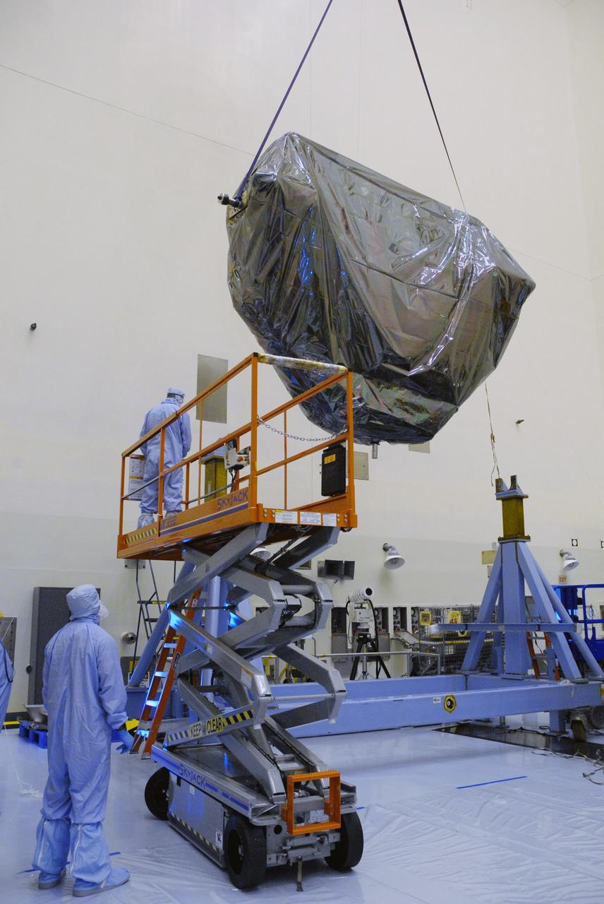 CAPE CANAVERAL, Fla. – In the Payload Hazardous Servicing Facility at NASA's Kennedy Space Center, an overhead crane lowers the Multi-Use Lightweight Equipment, or MULE, carrier toward a stand in the high bay. The MULE is part of the payload for the fifth and final shuttle servicing mission to NASA's Hubble Space Telescope, STS-125. The MULE carrier will join the Flight Support System, the Super Lightweight Interchangeable Carrier and the Orbital Replacement Unit Carrier in the Payload Hazardous Servicing Facility where the Hubble payload is being prepared for launch. The Relative Navigation Sensors and the New Outer Blanket Layers will be on the MULE. The payload is scheduled to go to Launch Pad 39A in mid-September to be installed into Atlantis' payload bay.  Atlantis is targeted to launch Oct. 8 at 1:34 a.m. EDT. Photo credit: NASA/Jack Pfaller