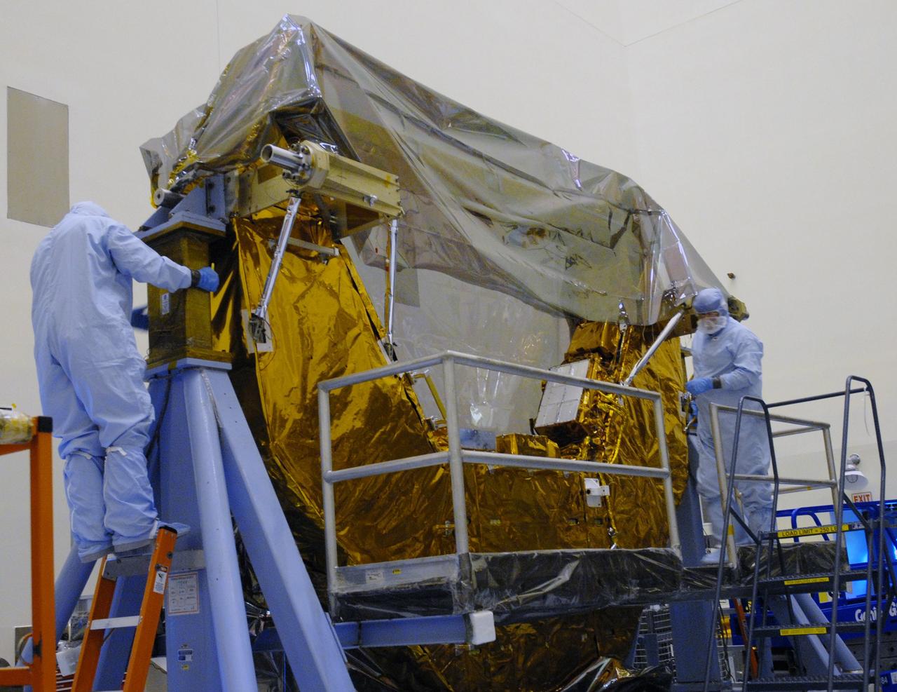 CAPE CANAVERAL, Fla. – In the Payload Hazardous Servicing Facility at NASA's Kennedy Space Center, technicians remove the protective cover from the Multi-Use Lightweight Equipment, or MULE, carrier. The MULE is part of the payload for the fifth and final shuttle servicing mission to NASA's Hubble Space Telescope, STS-125. The MULE carrier will join the Flight Support System, the Super Lightweight Interchangeable Carrier and the Orbital Replacement Unit Carrier in the Payload Hazardous Servicing Facility where the Hubble payload is being prepared for launch. The Relative Navigation Sensors and the New Outer Blanket Layers will be on the MULE. The payload is scheduled to go to Launch Pad 39A in mid-September to be installed into Atlantis' payload bay.  Atlantis is targeted to launch Oct. 8 at 1:34 a.m. EDT. Photo credit: NASA/Jack Pfaller
