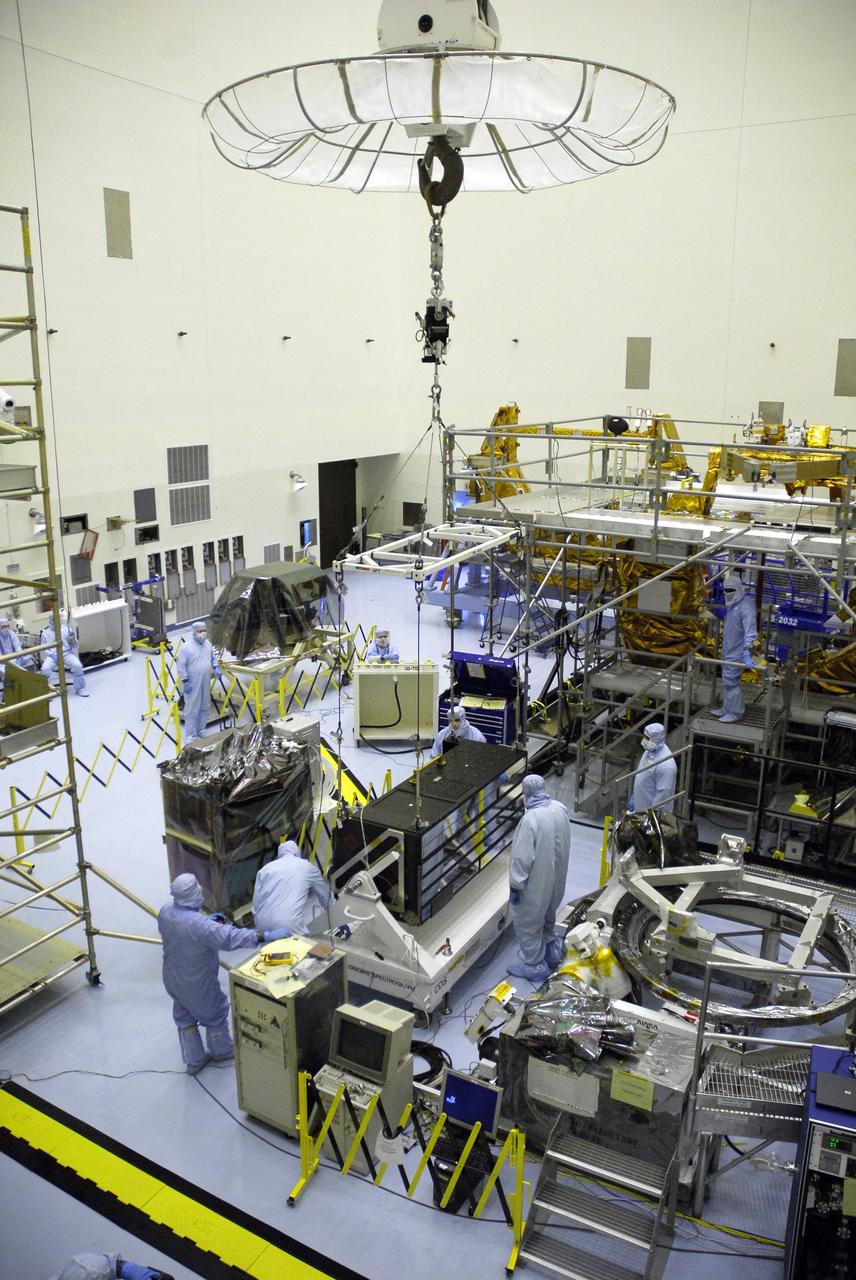 CAPE CANAVERAL, Fla. –  In the clean room of the Payload Hazardous Processing Facility at NASA's Kennedy Space Center, an overhead crane lifts the Cosmic Origins Spectrograph, or COS.  The COS is being lifted and moved to a protective enclosure on the Orbital Replacement Unit Carrier, part of the payload for the fifth and final Hubble servicing mission, STS-125.  Other payloads include the Flight Support System, the Super Lightweight Interchangeable Carrier and the Multi-Use Lightweight Equipment, or MULE, carrier. COS will be the most sensitive ultraviolet spectrograph ever flown on Hubble and will probe the "cosmic web" - the large-scale structure of the universe whose form is determined by the gravity of dark matter and is traced by galaxies and intergalactic gas. The COS far-ultraviolet channel has a sensitivity 30 times greater than that of previous spectroscopic instruments for the detection of extremely low light levels. Launch of Atlantis on the STS-125 mission is targeted for Oct. 8. Photo credit: NASA/Kim Shiflett