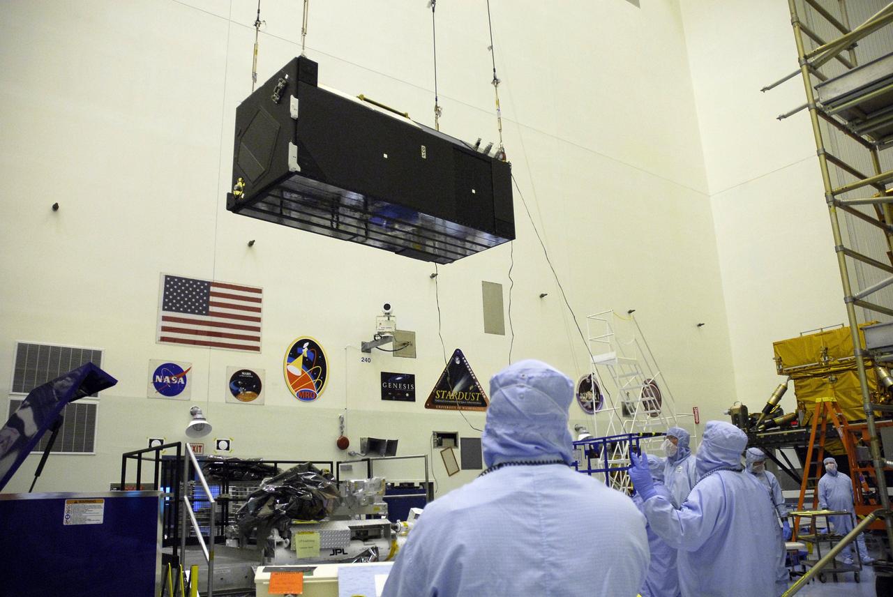 CAPE CANAVERAL, Fla. –  In the clean room of the Payload Hazardous Processing Facility at NASA's Kennedy Space Center, an overhead crane moves the Cosmic Origins Spectrograph, or COS, toward a protective enclosure on the Orbital Replacement Unit Carrier, part of the payload for the fifth and final Hubble servicing mission, STS-125.  Other payloads include the Flight Support System, the Super Lightweight Interchangeable Carrier and the Multi-Use Lightweight Equipment, or MULE, carrier. COS will be the most sensitive ultraviolet spectrograph ever flown on Hubble and will probe the "cosmic web" - the large-scale structure of the universe whose form is determined by the gravity of dark matter and is traced by galaxies and intergalactic gas. The COS far-ultraviolet channel has a sensitivity 30 times greater than that of previous spectroscopic instruments for the detection of extremely low light levels. Launch of Atlantis on the STS-125 mission is targeted for Oct. 8. Photo credit: NASA/Kim Shiflett