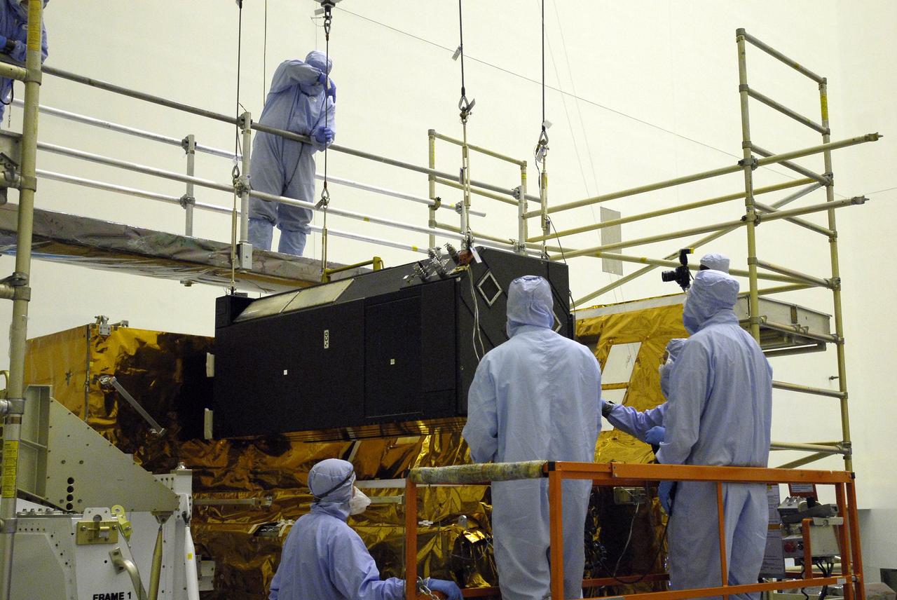 CAPE CANAVERAL, Fla. –    In the clean room of the Payload Hazardous Processing Facility at NASA's Kennedy Space Center, an overhead crane lowers the Cosmic Origins Spectrograph, or COS, into a protective enclosure on the Orbital Replacement Unit Carrier, part of the payload for the fifth and final Hubble servicing mission, STS-125. Other payloads include the Flight Support System, the Super Lightweight Interchangeable Carrier and the Multi-Use Lightweight Equipment, or MULE, carrier. COS will be the most sensitive ultraviolet spectrograph ever flown on Hubble and will probe the "cosmic web" - the large-scale structure of the universe whose form is determined by the gravity of dark matter and is traced by galaxies and intergalactic gas. The COS far-ultraviolet channel has a sensitivity 30 times greater than that of previous spectroscopic instruments for the detection of extremely low light levels. Launch of Atlantis on the STS-125 mission is targeted for Oct. 8. Photo credit: NASA/Kim Shiflett