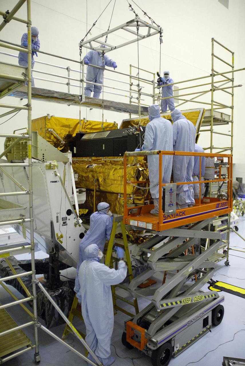 CAPE CANAVERAL, Fla. –  In the clean room of the Payload Hazardous Processing Facility at NASA's Kennedy Space Center, an overhead crane lowers the Cosmic Origins Spectrograph, or COS, into a protective enclosure on the Orbital Replacement Unit Carrier, part of the payload for the fifth and final Hubble servicing mission, STS-125.  Other payloads include the Flight Support System, the Super Lightweight Interchangeable Carrier and the Multi-Use Lightweight Equipment, or MULE, carrier. COS will be the most sensitive ultraviolet spectrograph ever flown on Hubble and will probe the "cosmic web" - the large-scale structure of the universe whose form is determined by the gravity of dark matter and is traced by galaxies and intergalactic gas. The COS far-ultraviolet channel has a sensitivity 30 times greater than that of previous spectroscopic instruments for the detection of extremely low light levels. Launch of Atlantis on the STS-125 mission is targeted for Oct. 8. Photo credit: NASA/Kim Shiflett