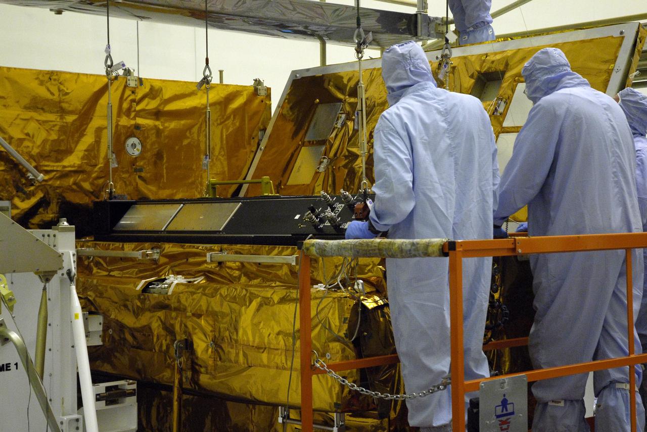 CAPE CANAVERAL, Fla. –   In the clean room of the Payload Hazardous Processing Facility at NASA's Kennedy Space Center, an overhead crane settles the Cosmic Origins Spectrograph, or COS, in a protective enclosure on the Orbital Replacement Unit Carrier, part of the payload for the fifth and final Hubble servicing mission, STS-125.  Other payloads include the Flight Support System, the Super Lightweight Interchangeable Carrier and the Multi-Use Lightweight Equipment, or MULE, carrier. COS will be the most sensitive ultraviolet spectrograph ever flown on Hubble and will probe the "cosmic web" - the large-scale structure of the universe whose form is determined by the gravity of dark matter and is traced by galaxies and intergalactic gas. The COS far-ultraviolet channel has a sensitivity 30 times greater than that of previous spectroscopic instruments for the detection of extremely low light levels. Launch of Atlantis on the STS-125 mission is targeted for Oct. 8. Photo credit: NASA/Kim Shiflett