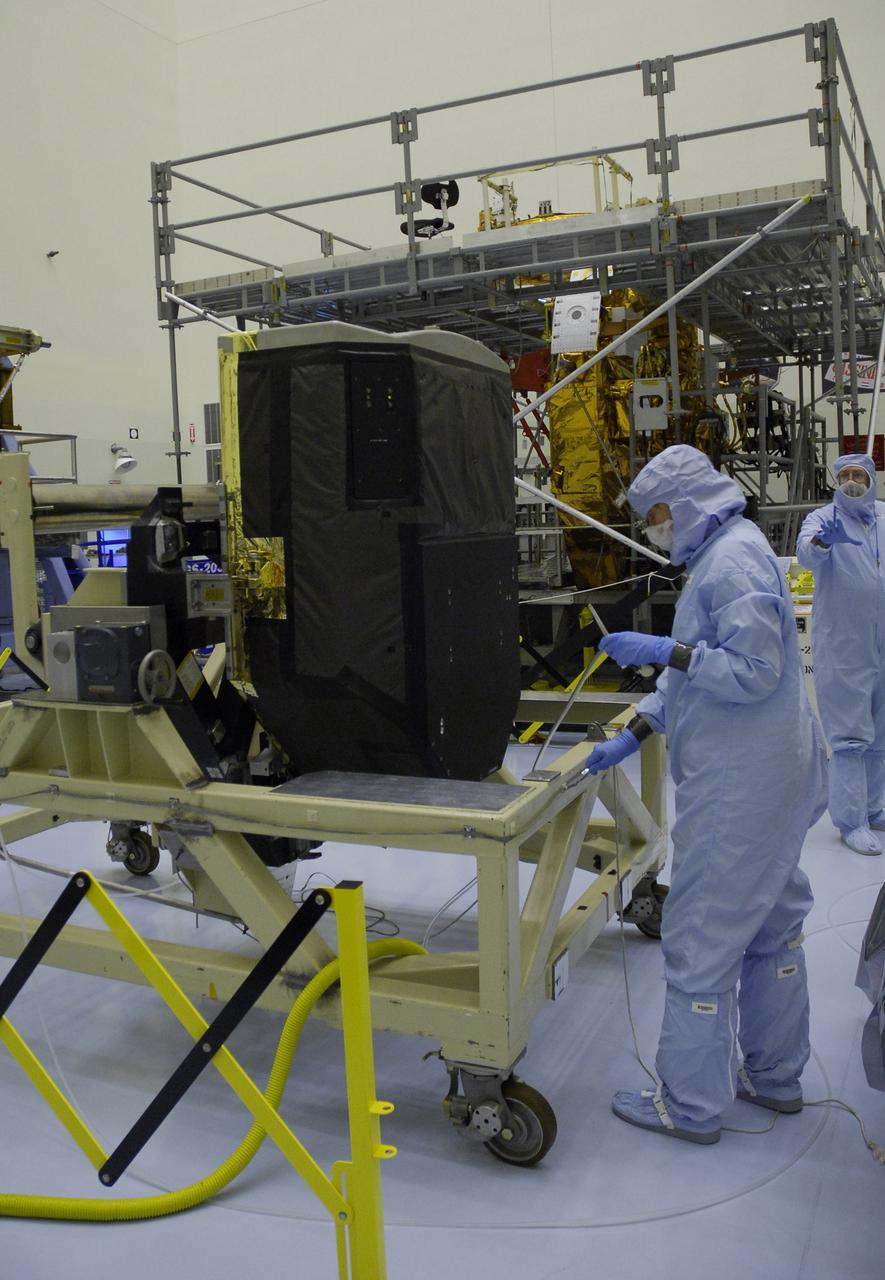 CAPE CANAVERAL, Fla. –   Technicians in the Payload Hazardous Servicing Facility at NASA's Kennedy Space Center are ready to move the Fine Guidance Sensor, or FGS, for integration onto the Orbital Replacement Unit Carrier, or ORUC.  An FGS consists of a large structure housing a collection of mirrors, lenses, servos, prisms, beam splitters and photomultiplier tubes. There are three fine guidance sensors on Hubble located at 90-degree intervals around the circumference of the telescope. Along with the gyroscopes, the optical sensors are a key component of Hubble’s highly complex but extraordinarily effective “pointing control system.”  Atlantis is targeted to launch Oct. 8. Photo credit: NASA/Jack Pfaller