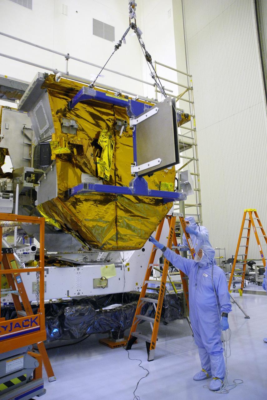 CAPE CANAVERAL, Fla. –  In the Payload Hazardous Servicing Facility at NASA's Kennedy Space Center, an overhead crane lowers the Fine Guidance Sensor Scientific Instrument Protective Enclosure, or FSIPE, cover alongside the Orbital Replacement Unit Carrier, or ORUC, for installation. The ORUC is one of three carriers that are being prepared for the integration of telescope science instruments, both internal and external replacement components, as well as the flight support equipment to be used by the astronauts during the fifth and final Hubble servicing mission, STS-125.   Launch is targeted for Oct. 8. PHoto credit: NASA/Jack Pfaller