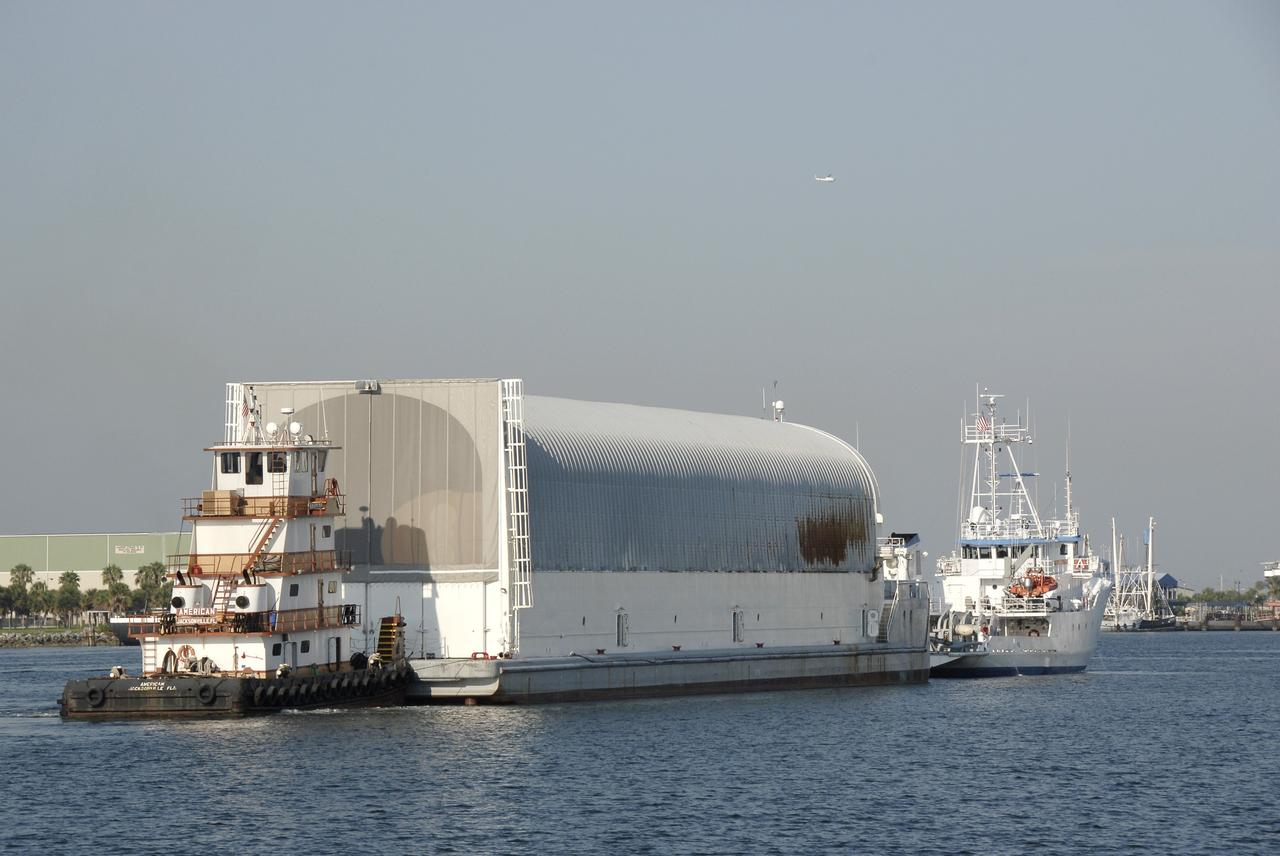 CAPE CANAVERAL, Fla. – The Pegasus barge containing the external fuel tank for space shuttle Endeavour's STS-126 mission to the International Space Station arrives in Port Canaveral, Fla., after an ocean voyage under tow by one of the solid rocket booster retrieval ships (at right) from the Michoud Assembly Facility near New Orleans. The barge is heading for the Launch Complex 39 Area at NASA's Kennedy Space Center. The tank will be offloaded at the turn basin near the Vehicle Assembly Building and transported to the VAB. There it will be lifted and lowered into a checkout cell. The STS-126 mission will deliver a Multi-Purpose Logistics Module to the International Space Station. Launch is targeted for Nov. 10. Photo credit: NASA/Kim Shiflett