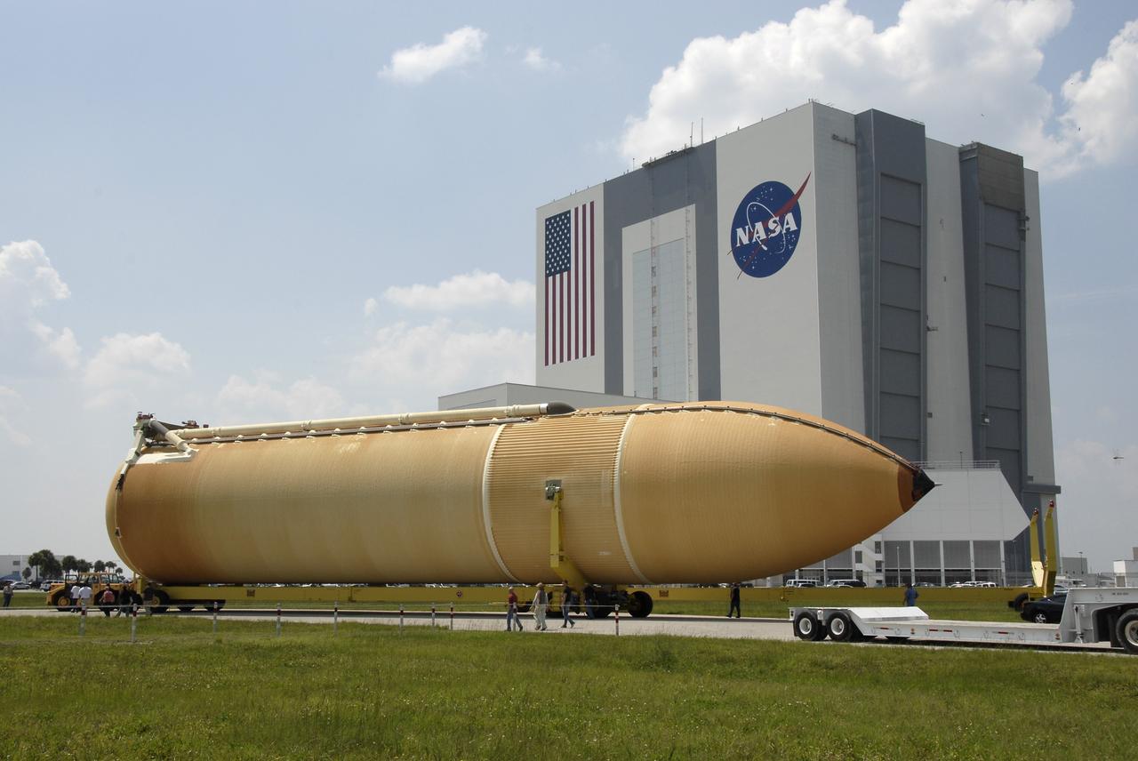 CAPE CANAVERAL, Fla. – After being offloaded from the Pegasus barge at the turn basin dock, the external fuel tank for space shuttle Endeavour's STS-126 mission to the International Space Station is transported to the Vehicle Assembly Building, seen behind it, at NASA's Kennedy Space Center. The tank arrived earlier after a six-day ocean voyage towed by a solid rocket booster retrieval ship from the Michoud Assembly Facility near New Orleans. The tank will be transported to the VAB transfer aisle, lifted and lowered into a checkout cell. The STS-126 mission will deliver a Multi-Purpose Logistics Module to the International Space Station. Launch is targeted for Nov. 10. Photo credit: NASA/Kim Shiflett