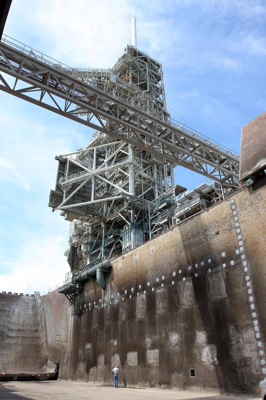 CAPE CANAVERAL, Fla. – An inspector stands in the Launch Pad 39A flame trench at NASA's Kennedy Space Center after tests of the repairs on the wall. Workers sprayed a heat-resistant concrete called Fondue Fyre into steel grid structures, welded to the wall of the flame trench. Fondue Fyre was developed during NASA's Apollo lunar program. Damage to the trench occurred during the launch of space shuttle Discovery on the STS-124 mission. A 75-foot by 20-foot section of the east wall was destroyed and debris scattered as far as the pad perimeter fence. Repairs being completed before the targeted Oct. 8 launch of Atlantis on the NASA Hubble Space Telescope servicing mission. Photo credit: NASA/Dimitri Gerondidakis