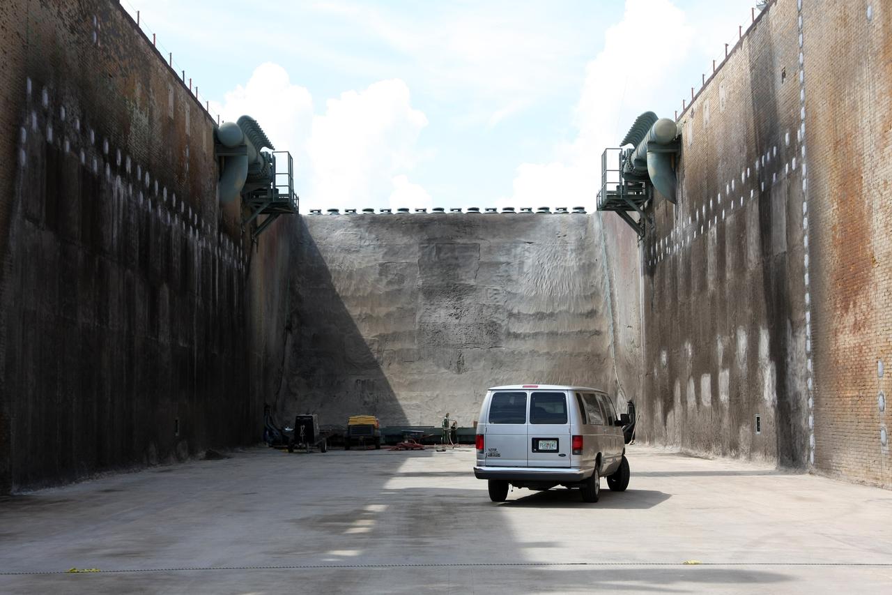 CAPE CANAVERAL, Fla. – A van travels the width of the Launch Pad 39A flame trench at NASA's Kennedy Space Center after tests of the repairs on the wall. Workers sprayed a heat-resistant concrete called Fondue Fyre into steel grid structures, welded to the wall of the flame trench. Fondue Fyre was developed during NASA's Apollo lunar program. Damage to the trench occurred during the launch of space shuttle Discovery on the STS-124 mission. A 75-foot by 20-foot section of the east wall was destroyed and debris scattered as far as the pad perimeter fence. Repairs being completed before the targeted Oct. 8 launch of Atlantis on the NASA Hubble Space Telescope servicing mission. Photo credit: NASA/Dimitri Gerondidakis