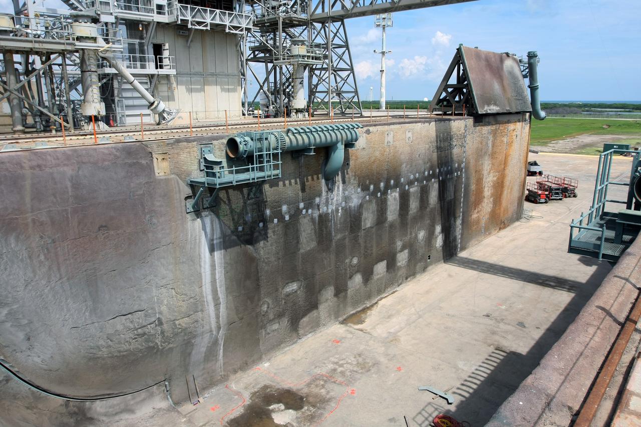 CAPE CANAVERAL, Fla. – A view from above of repairs made to the walls of the Launch Pad 39A flame trench at NASA's Kennedy Space Center. Workers sprayed a heat-resistant concrete called Fondue Fyre into steel grid structures, welded to the wall of the flame trench. Fondue Fyre was developed during NASA's Apollo lunar program. Damage to the trench occurred during the launch of space shuttle Discovery on the STS-124 mission. A 75-foot by 20-foot section of the east wall was destroyed and debris scattered as far as the pad perimeter fence. Repairs being completed before the targeted Oct. 8 launch of Atlantis on the NASA Hubble Space Telescope servicing mission. Photo credit: NASA/Dimitri Gerondidakis