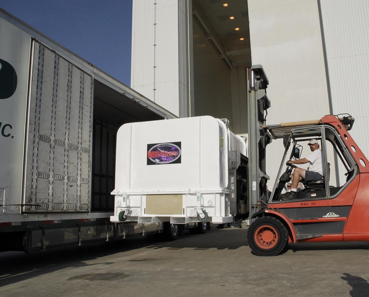 CAPE CANAVERAL, Fla. –  The shipping container with the Wide Field Camera 3, or WFC3, inside is removed from the truck outside the Payload Hazardous Servicing Facility at NASA's Kennedy Space Center. As Hubble enters the last stage of its life, WFC3  will be Hubble's next evolutionary step, allowing Hubble to peer ever further into the mysteries of the cosmos. WFC3 will study a diverse range of objects and phenomena, from young and extremely distant galaxies, to much more nearby stellar systems, to objects within our very own solar system.  WFC3 will take the place of Wide Field Planetary Camera 2, which astronauts will bring back to Earth aboard the shuttle. WFC3 is part of the payload on the fifth and final Hubble servicing mission, STS-125, targeted for launch Oct. 8. Photo credit: NASA/Jack Pfaller