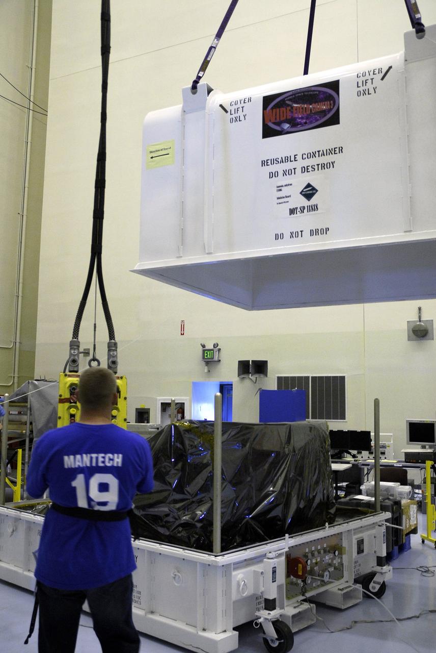 CAPE CANAVERAL, Fla. –  In the Payload Hazardous Servicing Facility at NASA's Kennedy Space Center, the cover of the Wide Field Camera 3, or WFC3, shipping container is lifted away from the mobile base.  As Hubble enters the last stage of its life, WFC3  will be Hubble's next evolutionary step, allowing Hubble to peer ever further into the mysteries of the cosmos. WFC3 will study a diverse range of objects and phenomena, from young and extremely distant galaxies, to much more nearby stellar systems, to objects within our very own solar system.  WFC3 will take the place of Wide Field Planetary Camera 2, which astronauts will bring back to Earth aboard the shuttle. WFC3 is part of the payload on the fifth and final Hubble servicing mission, STS-125, targeted for launch Oct. 8.  Photo credit: NASA/Jack Pfaller