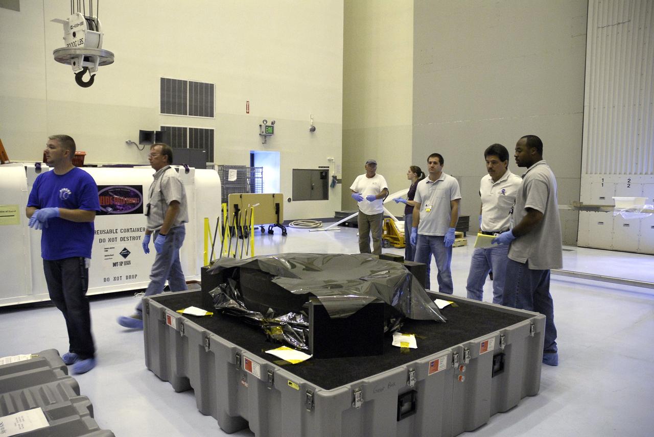 CAPE CANAVERAL, Fla. – In the Payload Hazardous Servicing Facility at NASA's Kennedy Space Center, the Soft Capture and Rendezvous System, or SCRS, is revealed after removal of the shipping container cover. The SCRS will enable the future rendezvous, capture and safe disposal of Hubble by either a crewed or robotic mission. The SCRS greatly increases the current shuttle capture interfaces on Hubble, therefore significantly reducing the rendezvous and capture design complexities associated with the disposal mission. The SCRS comprises the Soft Capture Mechanism system and the Relative Navigation System and is part of the payload on the fifth and final Hubble servicing mission, STS-125, targeted for launch Oct. 8. Photo credit: NASA/Jack Pfaller