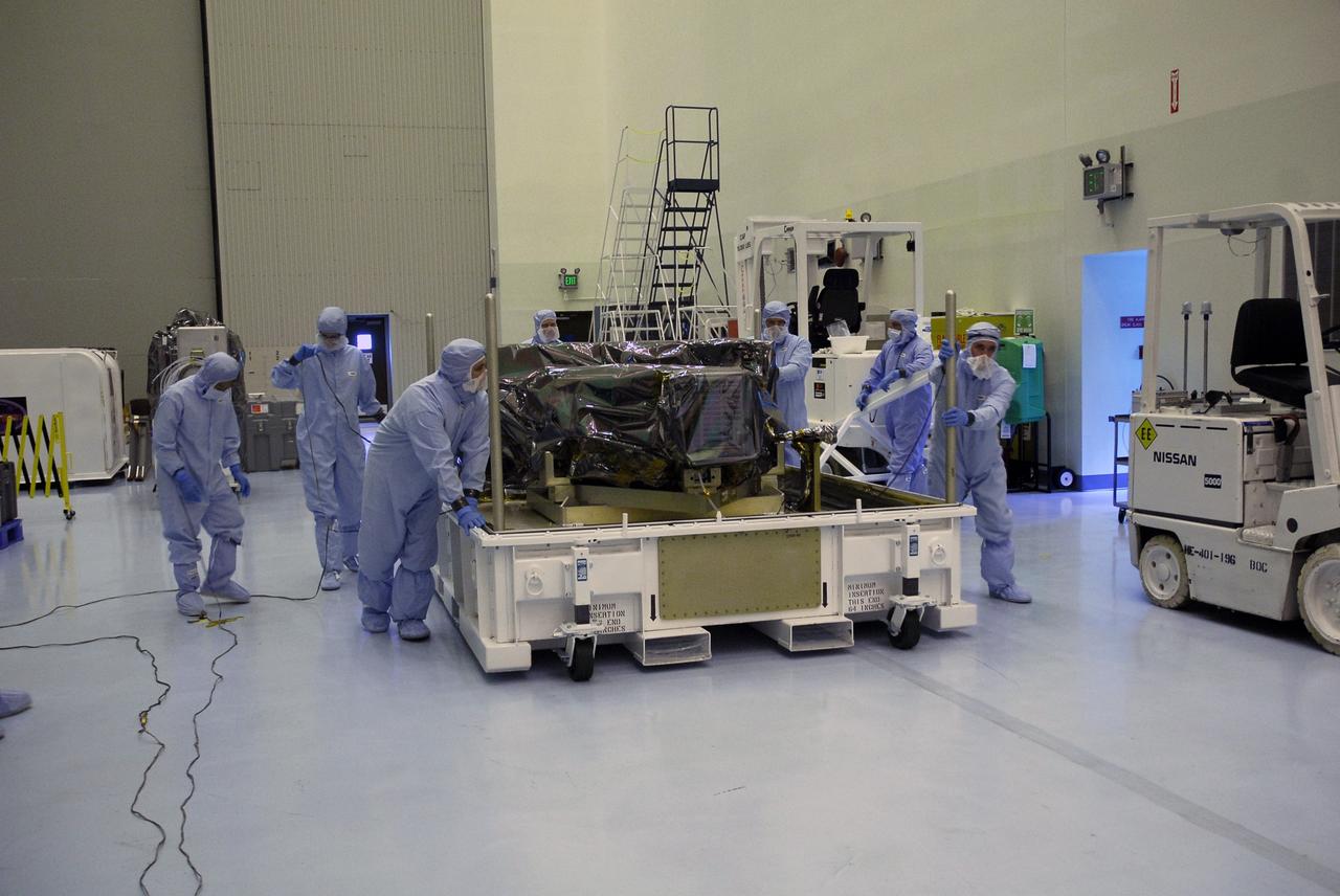 CAPE CANAVERAL, Fla. – In the Payload Hazardous Servicing Facility at NASA's Kennedy Space Center, technicians move the base of the shipping container holding the Wide Field Camera 3, or WFC3.  As Hubble enters the last stage of its life, WFC3  will be Hubble's next evolutionary step, allowing Hubble to peer ever further into the mysteries of the cosmos. WFC3 will study a diverse range of objects and phenomena, from young and extremely distant galaxies, to much more nearby stellar systems, to objects within our very own solar system.  WFC3 will take the place of Wide Field Planetary Camera 2, which astronauts will bring back to Earth aboard the shuttle. WFC3 is part of the payload on the fifth and final Hubble servicing mission, STS-125, targeted for launch Oct. 8. Photo credit: NASA/Jack Pfaller