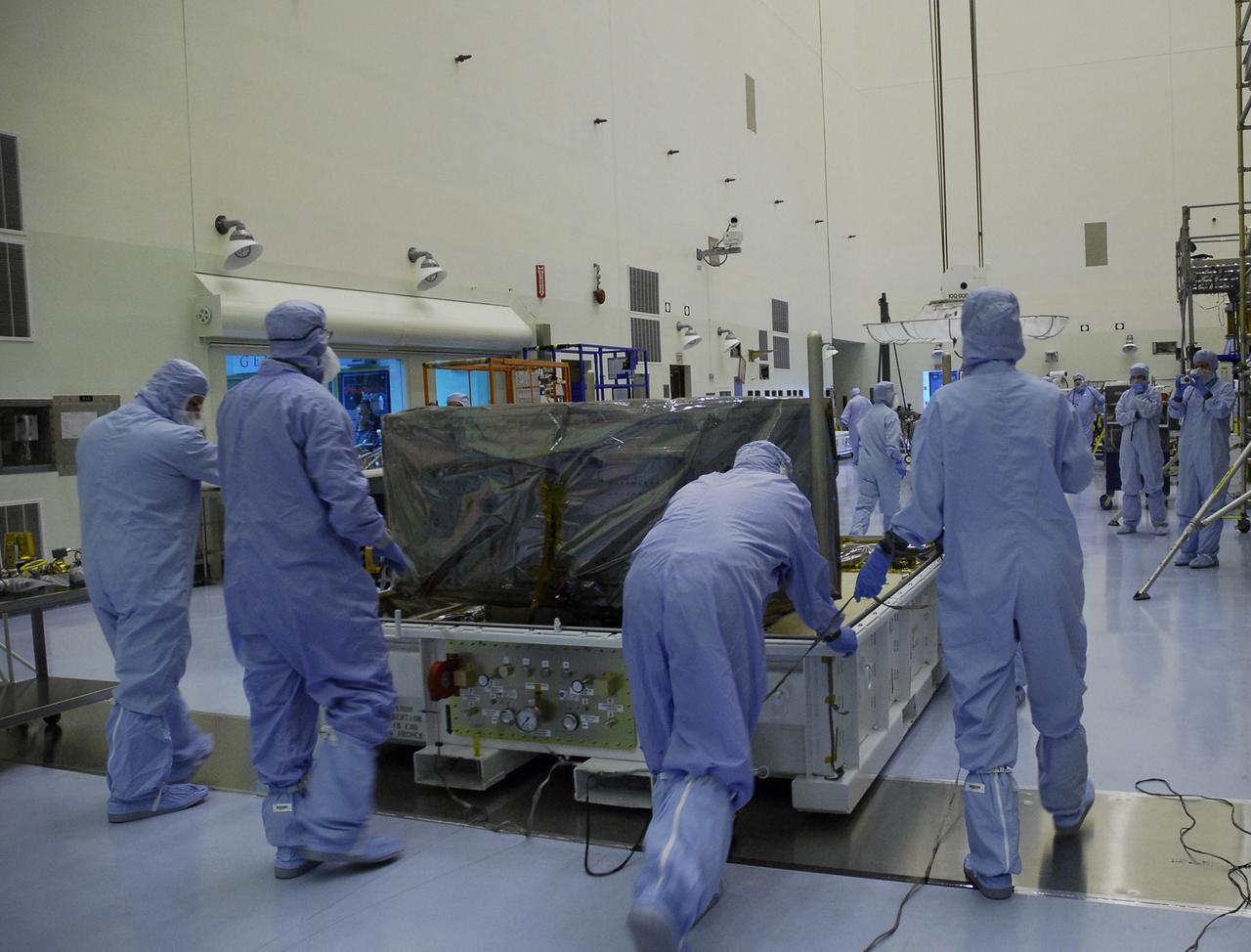 CAPE CANAVERAL, Fla. – In the Payload Hazardous Servicing Facility at NASA's Kennedy Space Center, technicians move the base of the shipping container holding the Wide Field Camera 3, or WFC3, into the high bay.  As Hubble enters the last stage of its life, WFC3  will be Hubble's next evolutionary step, allowing Hubble to peer ever further into the mysteries of the cosmos. WFC3 will study a diverse range of objects and phenomena, from young and extremely distant galaxies, to much more nearby stellar systems, to objects within our very own solar system.  WFC3 will take the place of Wide Field Planetary Camera 2, which astronauts will bring back to Earth aboard the shuttle. WFC3 is part of the payload on the fifth and final Hubble servicing mission, STS-125, targeted for launch Oct. 8. Photo credit: NASA/Jack Pfaller