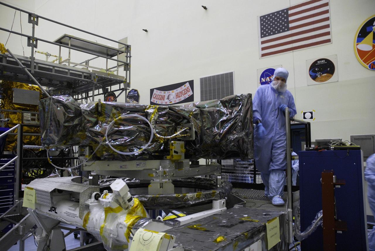 CAPE CANAVERAL, Fla. –  In the Payload Hazardous Servicing Facility at NASA's Kennedy Space Center, technicians monitor the placement of the Wide Field Camera 3, or WFC3, on a work stand. As Hubble enters the last stage of its life, WFC3  will be Hubble's next evolutionary step, allowing Hubble to peer ever further into the mysteries of the cosmos. WFC3 will study a diverse range of objects and phenomena, from young and extremely distant galaxies, to much more nearby stellar systems, to objects within our very own solar system.  WFC3 will take the place of Wide Field Planetary Camera 2, which astronauts will bring back to Earth aboard the shuttle. WFC3 is part of the payload on the fifth and final Hubble servicing mission, STS-125, targeted for launch Oct. 8. Photo credit: NASA/Jack Pfaller