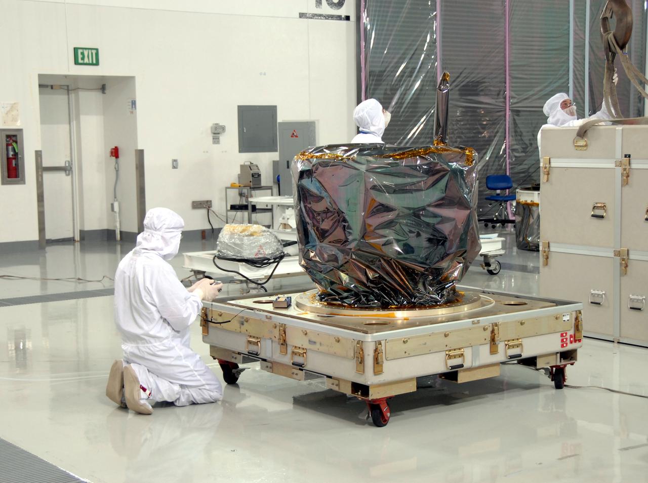 VANDENBERG AIR FORCE BASE, Calif. – At Vandenberg Air Force Base in California, technicians prepare NASA's Interstellar Boundary Explorer, or IBEX, mission spacecraft to be lifted from the shipping platform and moved to a mobile stand in the background. The IBEX satellite will make the first map of the boundary between the Solar System and interstellar space. IBEX is the first mission designed to detect the edge of the Solar System. As the solar wind from the sun flows out beyond Pluto, it collides with the material between the stars, forming a shock front. IBEX contains two neutral atom imagers designed to detect particles from the termination shock at the boundary between the Solar System and interstellar space. IBEX also will study galactic cosmic rays, energetic particles from beyond the Solar System that pose a health and safety hazard for humans exploring beyond Earth orbit. IBEX will make these observations from a highly elliptical orbit that takes it beyond the interference of the Earth's magnetosphere. IBEX is targeted for launch from the Pegasus XL rocket on Oct. 5. Photo credit: NASA/Mark Mackley