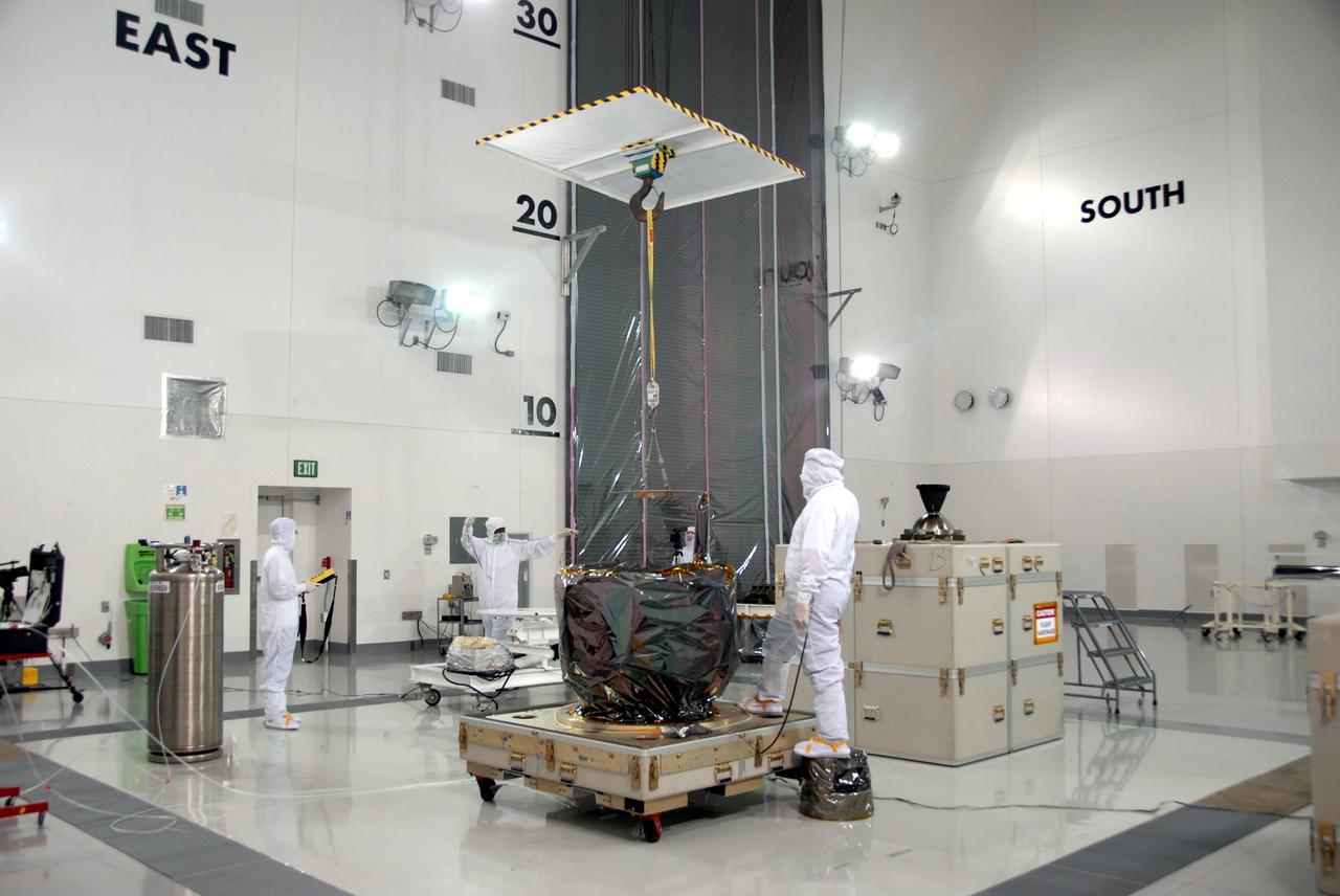 VANDENBERG AIR FORCE BASE, Calif. – At Vandenberg Air Force Base in California, an overhead crane is ready to lift NASA's Interstellar Boundary Explorer, or IBEX, mission spacecraft and move it to a nearby mobile stand.The IBEX satellite will make the first map of the boundary between the Solar System and interstellar space. IBEX is the first mission designed to detect the edge of the Solar System. As the solar wind from the sun flows out beyond Pluto, it collides with the material between the stars, forming a shock front. IBEX contains two neutral atom imagers designed to detect particles from the termination shock at the boundary between the Solar System and interstellar space. IBEX also will study galactic cosmic rays, energetic particles from beyond the Solar System that pose a health and safety hazard for humans exploring beyond Earth orbit. IBEX will make these observations from a highly elliptical orbit that takes it beyond the interference of the Earth's magnetosphere. IBEX is targeted for launch from the Pegasus XL rocket on Oct. 5. Photo credit: NASA/Mark Mackley