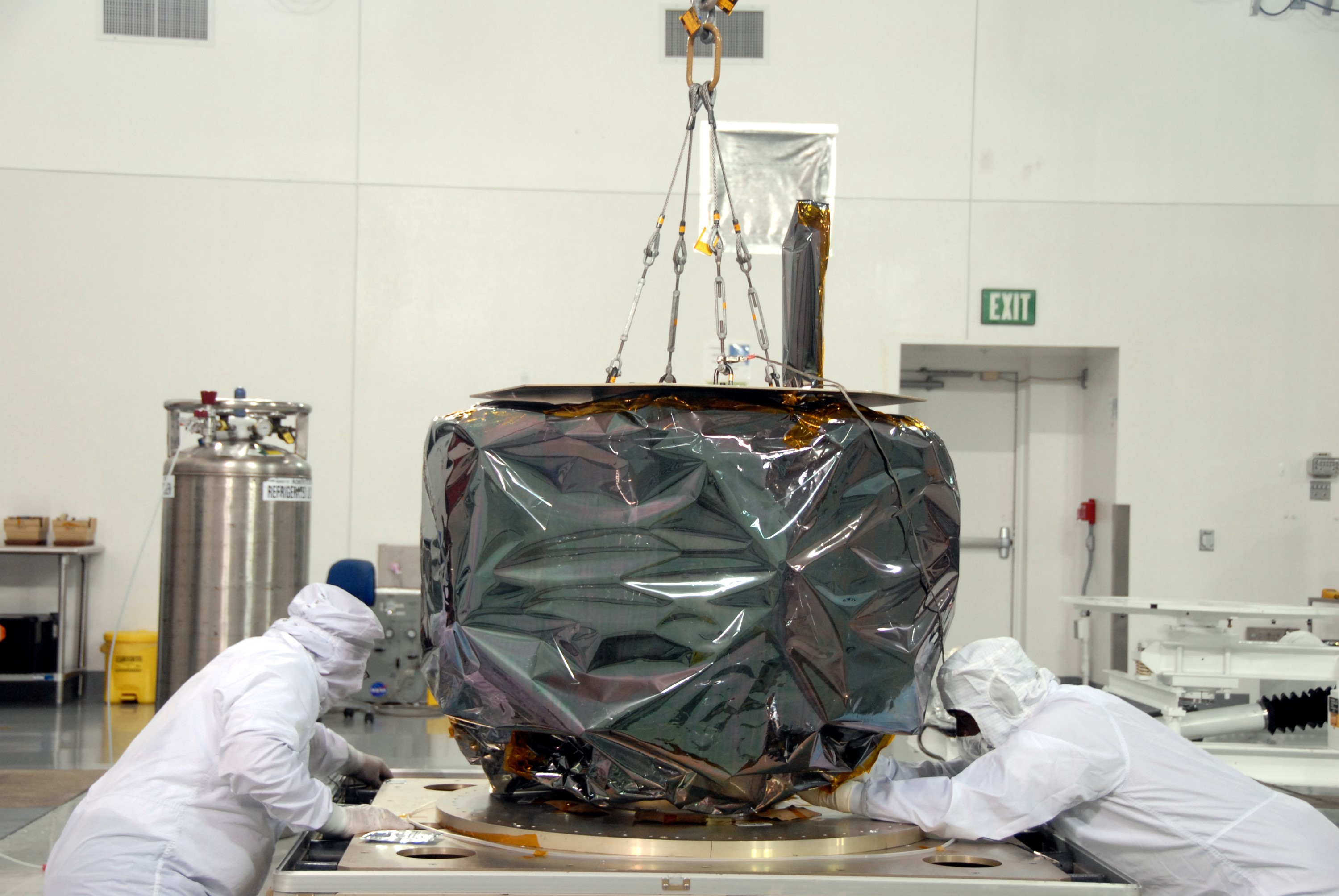 VANDENBERG AIR FORCE BASE, Calif. – At Vandenberg Air Force Base in California, technicians check the base of NASA's Interstellar Boundary Explorer, or IBEX, mission spacecraft as it is lifted off its shipping stand. The spacecraft will be moved to a nearby mobile stand. The IBEX satellite will make the first map of the boundary between the Solar System and interstellar space. IBEX is the first mission designed to detect the edge of the Solar System. As the solar wind from the sun flows out beyond Pluto, it collides with the material between the stars, forming a shock front. IBEX contains two neutral atom imagers designed to detect particles from the termination shock at the boundary between the Solar System and interstellar space. IBEX also will study galactic cosmic rays, energetic particles from beyond the Solar System that pose a health and safety hazard for humans exploring beyond Earth orbit. IBEX will make these observations from a highly elliptical orbit that takes it beyond the interference of the Earth's magnetosphere. IBEX is targeted for launch from the Pegasus XL rocket on Oct. 5. Photo credit: NASA