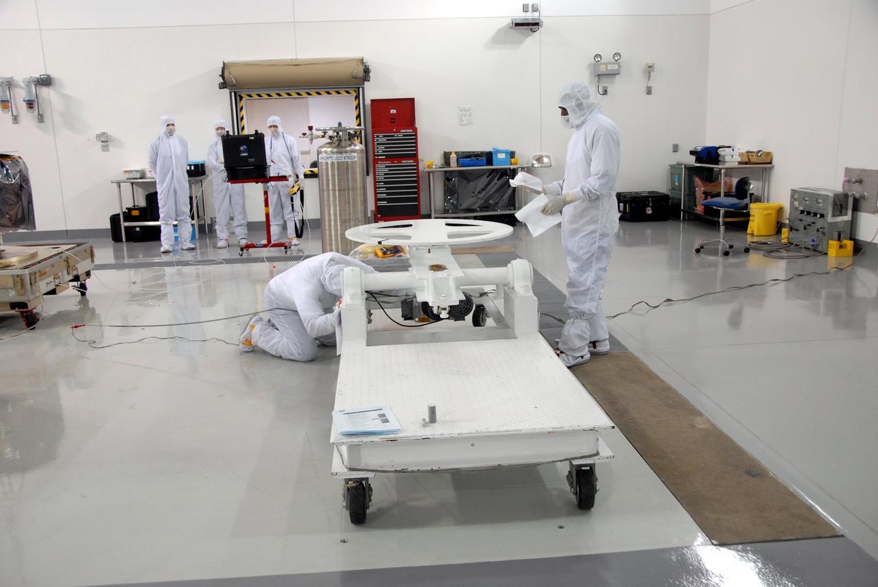 VANDENBERG AIR FORCE BASE, Calif. – At Vandenberg Air Force Base in California, technicians prepare a mobile stand to receive NASA's Interstellar Boundary Explorer, or IBEX, mission spacecraft. The IBEX satellite will make the first map of the boundary between the Solar System and interstellar space. IBEX is the first mission designed to detect the edge of the Solar System. As the solar wind from the sun flows out beyond Pluto, it collides with the material between the stars, forming a shock front. IBEX contains two neutral atom imagers designed to detect particles from the termination shock at the boundary between the Solar System and interstellar space. IBEX also will study galactic cosmic rays, energetic particles from beyond the Solar System that pose a health and safety hazard for humans exploring beyond Earth orbit. IBEX will make these observations from a highly elliptical orbit that takes it beyond the interference of the Earth's magnetosphere. IBEX is targeted for launch from the Pegasus XL rocket on Oct. 5. Photo credit: NASA