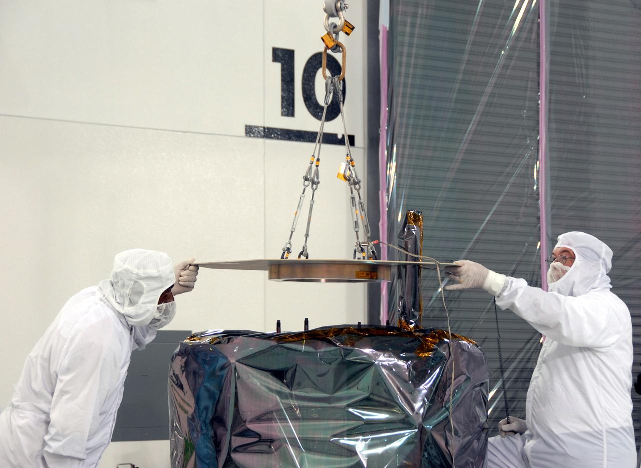 VANDENBERG AIR FORCE BASE, Calif. – At Vandenberg Air Force Base in California, technicians release the overhead crane from NASA's Interstellar Boundary Explorer, or IBEX, mission spacecraft which rests on the mobile stand. The IBEX satellite will make the first map of the boundary between the Solar System and interstellar space. IBEX is the first mission designed to detect the edge of the Solar System. As the solar wind from the sun flows out beyond Pluto, it collides with the material between the stars, forming a shock front. IBEX contains two neutral atom imagers designed to detect particles from the termination shock at the boundary between the Solar System and interstellar space. IBEX also will study galactic cosmic rays, energetic particles from beyond the Solar System that pose a health and safety hazard for humans exploring beyond Earth orbit. IBEX will make these observations from a highly elliptical orbit that takes it beyond the interference of the Earth's magnetosphere. IBEX is targeted for launch from the Pegasus XL rocket on Oct. 5. Photo credit: NASA