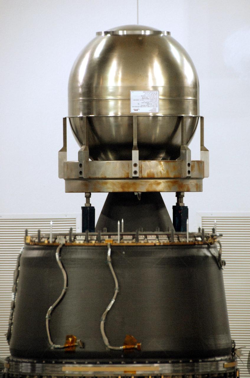 VANDENBERG AIR FORCE BASE, Calif. – At Vandenberg Air Force Base in California, the Star-27 kick motor and nozzle for NASA's Interstellar Boundary Explorer, or IBEX, spacecraft are “on top” and part of the IBEX flight system, known as the adapter cone, is in the foreground/bottom. The Star-27 motor has a silver tank that contains the solid propellant. The nozzle fits down inside the adapter cone. The IBEX satellite will make the first map of the boundary between the Solar System and interstellar space. IBEX is the first mission designed to detect the edge of the Solar System. As the solar wind from the sun flows out beyond Pluto, it collides with the material between the stars, forming a shock front. IBEX contains two neutral atom imagers designed to detect particles from the termination shock at the boundary between the Solar System and interstellar space. IBEX also will study galactic cosmic rays, energetic particles from beyond the Solar System that pose a health and safety hazard for humans exploring beyond Earth orbit. IBEX will make these observations from a highly elliptical orbit that takes it beyond the interference of the Earth's magnetosphere. IBEX is targeted for launch from the Pegasus XL rocket on Oct. 5. Photo credit: NASA/R. Bledsoe