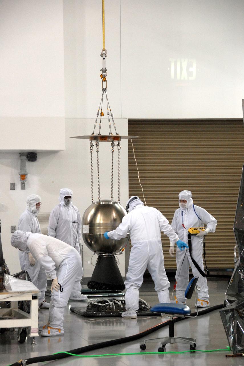 VANDENBERG AIR FORCE BASE, Calif. – At Vandenberg Air Force Base in California, the Star-27 kick motor and nozzle for NASA's Interstellar Boundary Explorer, or IBEX, spacecraft is being hoisted before insertion into the adapter cone. The IBEX satellite will make the first map of the boundary between the Solar System and interstellar space. IBEX is the first mission designed to detect the edge of the Solar System. As the solar wind from the sun flows out beyond Pluto, it collides with the material between the stars, forming a shock front. IBEX contains two neutral atom imagers designed to detect particles from the termination shock at the boundary between the Solar System and interstellar space. IBEX also will study galactic cosmic rays, energetic particles from beyond the Solar System that pose a health and safety hazard for humans exploring beyond Earth orbit. IBEX will make these observations from a highly elliptical orbit that takes it beyond the interference of the Earth's magnetosphere. IBEX is targeted for launch from the Pegasus XL rocket on Oct. 5. Photo credit: NASA/R. Bledsoe