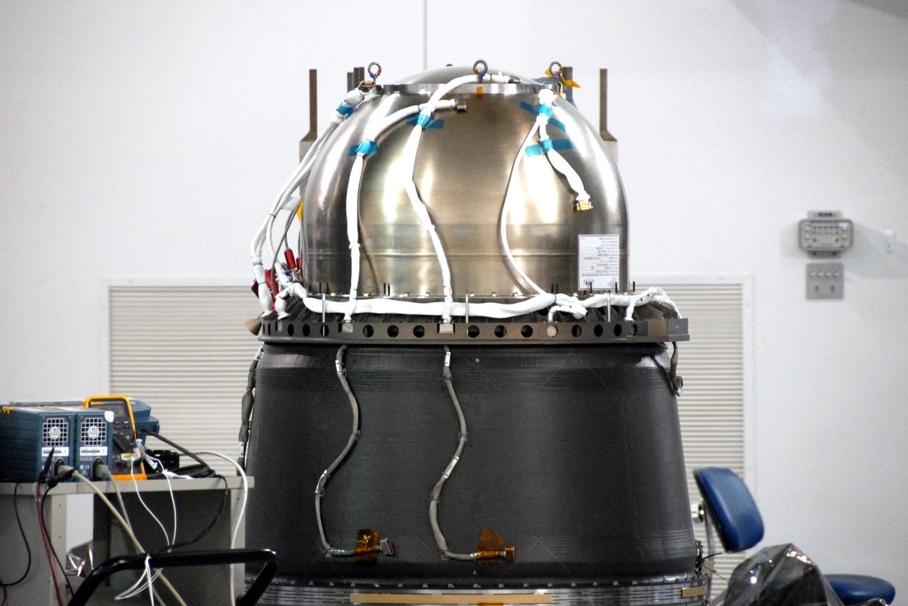 VANDENBERG AIR FORCE BASE, Calif. – At Vandenberg Air Force Base in California, the Star-27 kick motor and nozzle for NASA's Interstellar Boundary Explorer, or IBEX, spacecraft have been inserted into the adapter cone. The IBEX satellite will make the first map of the boundary between the Solar System and interstellar space. IBEX is the first mission designed to detect the edge of the Solar System. As the solar wind from the sun flows out beyond Pluto, it collides with the material between the stars, forming a shock front. IBEX contains two neutral atom imagers designed to detect particles from the termination shock at the boundary between the Solar System and interstellar space. IBEX also will study galactic cosmic rays, energetic particles from beyond the Solar System that pose a health and safety hazard for humans exploring beyond Earth orbit. IBEX will make these observations from a highly elliptical orbit that takes it beyond the interference of the Earth's magnetosphere. IBEX is targeted for launch from the Pegasus XL rocket on Oct. 5. Photo credit: NASA/R. Bledsoe