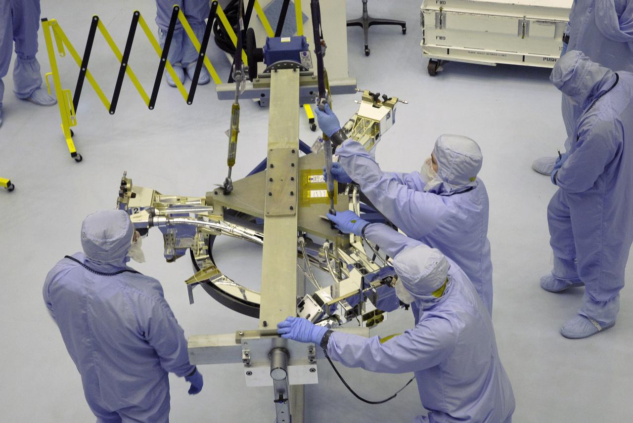 CAPE CANAVERAL, Fla. – In the Payload Hazardous Servicing Facility at NASA's Kennedy Space Center, technicians attach a crane to the Soft Capture Mechanism (SCM), part of the Soft Capture and Rendezvous System, or SCRS. The SCM will be lifted and transferred to the stand holding the Flight Support System, or FSS, carrier, where the SCM will be mated to the FSS. The SCRS will enable the future rendezvous, capture and safe disposal of NASA's Hubble Space Telescope by either a crewed or robotic mission. The ring-like device attaches to Hubble’s aft bulkhead. The SCRS greatly increases the current shuttle capture interfaces on Hubble, therefore significantly reducing the rendezvous and capture design complexities associated with the disposal mission. The FSS will join the Multi-Use Lightweight Equipment, or MULE, carrier, the Super Lightweight Interchangeable Carrier and the Orbital Replacement Unit Carrier as payload on space shuttle Atlantis's STS-125 mission. The payload is scheduled to go to Launch Pad 39A in mid-September to be installed into Atlantis' payload bay. Atlantis is targeted to launch Oct. 8 at 1:34 a.m. EDT. Photo credit: NASA/Troy Cryder