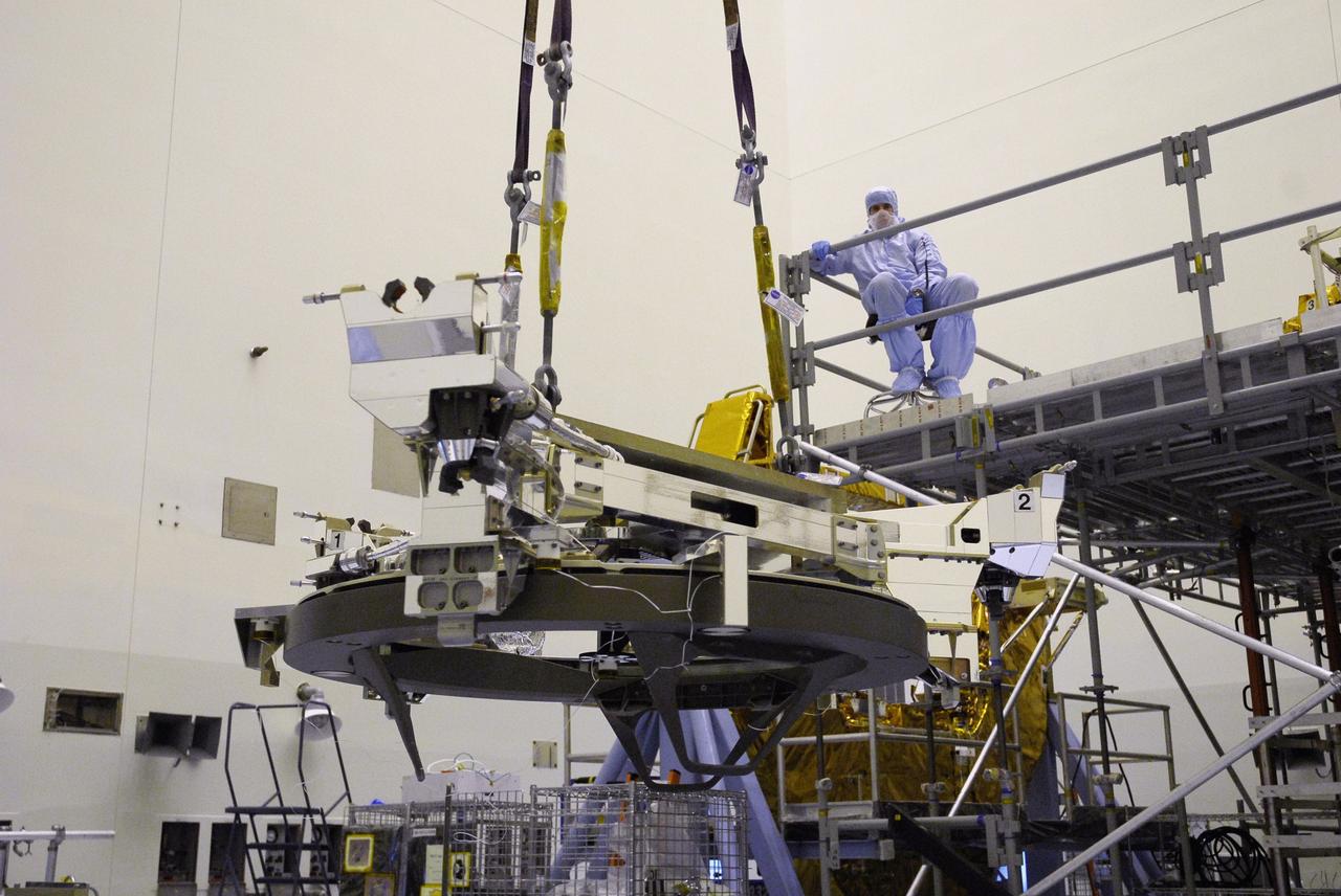 CAPE CANAVERAL, Fla. – In the Payload Hazardous Servicing Facility at NASA's Kennedy Space Center, the Soft Capture Mechanism (SCM), part of the Soft Capture and Rendezvous System, or SCRS, moves above the floor toward the stand holding the Flight Support System, or FSS, carrier where the SCM will be mated to the FSS. The SCRS will enable the future rendezvous, capture and safe disposal of NASA's Hubble Space Telescope by either a crewed or robotic mission. The ring-like device attaches to Hubble’s aft bulkhead. The SCRS greatly increases the current shuttle capture interfaces on Hubble, therefore significantly reducing the rendezvous and capture design complexities associated with the disposal mission. The FSS will join the Multi-Use Lightweight Equipment, or MULE, carrier, the Super Lightweight Interchangeable Carrier and the Orbital Replacement Unit Carrier as payload on space shuttle Atlantis's STS-125 mission. The payload is scheduled to go to Launch Pad 39A in mid-September to be installed into Atlantis' payload bay. Atlantis is targeted to launch Oct. 8 at 1:34 a.m. EDT. Photo credit: NASA/Troy Cryder