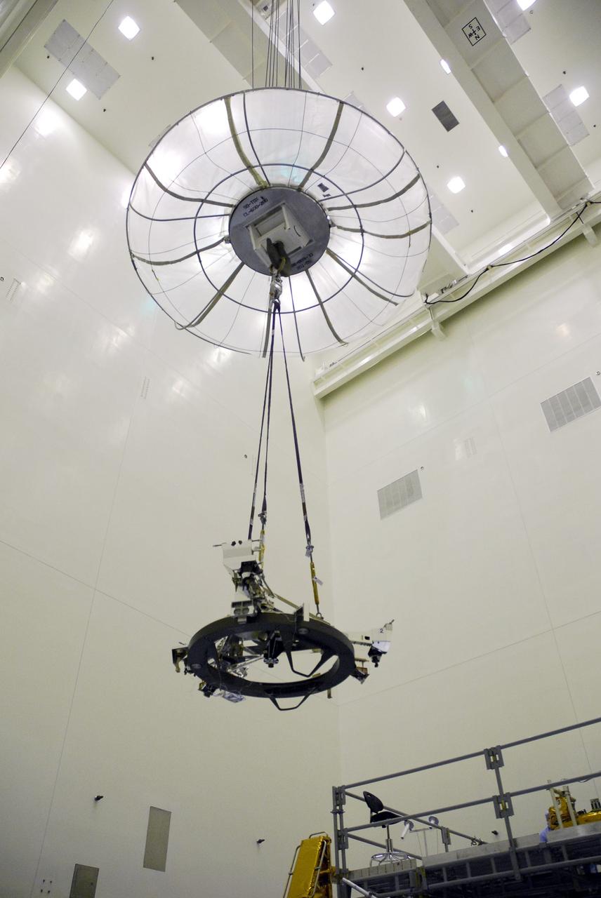 CAPE CANAVERAL, Fla. – In the Payload Hazardous Servicing Facility at NASA's Kennedy Space Center, the Soft Capture Mechanism (SCM), part of the Soft Capture and Rendezvous System, or SCRS, moves above the floor via an overhead crane toward the stand holding the Flight Support System, or FSS,carrier where the SCM will be mated to the FSS. The SCRS will enable the future rendezvous, capture and safe disposal of NASA's Hubble Space Telescope by either a crewed or robotic mission. The ring-like device attaches to Hubble’s aft bulkhead. The SCRS greatly increases the current shuttle capture interfaces on Hubble, therefore significantly reducing the rendezvous and capture design complexities associated with the disposal mission. The FSS will join the Multi-Use Lightweight Equipment, or MULE, carrier, the Super Lightweight Interchangeable Carrier and the Orbital Replacement Unit Carrier as payload on space shuttle Atlantis's STS-125 mission. The payload is scheduled to go to Launch Pad 39A in mid-September to be installed into Atlantis' payload bay. Atlantis is targeted to launch Oct. 8 at 1:34 a.m. EDT. Photo credit: NASA/Troy Cryder