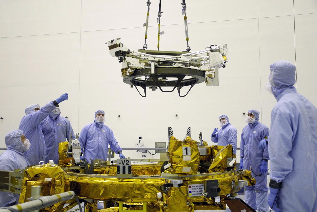 CAPE CANAVERAL, Fla. – In the Payload Hazardous Servicing Facility at NASA's Kennedy Space Center, an overhead crane lowers the Soft Capture Mechanism (SCM), part of the Soft Capture and Rendezvous System, or SCRS, toward the Flight Support System, or FSS, carrier. The SCRS will enable the future rendezvous, capture and safe disposal of NASA's Hubble Space Telescope by either a crewed or robotic mission. The ring-like device attaches to Hubble’s aft bulkhead. The SCRS greatly increases the current shuttle capture interfaces on Hubble, therefore significantly reducing the rendezvous and capture design complexities associated with the disposal mission. The FSS will join the Multi-Use Lightweight Equipment, or MULE, carrier, the Super Lightweight Interchangeable Carrier and the Orbital Replacement Unit Carrier as payload on space shuttle Atlantis's STS-125 mission. The payload is scheduled to go to Launch Pad 39A in mid-September to be installed into Atlantis' payload bay. Atlantis is targeted to launch Oct. 8 at 1:34 a.m. EDT. Photo credit: NASA/Troy Cryder